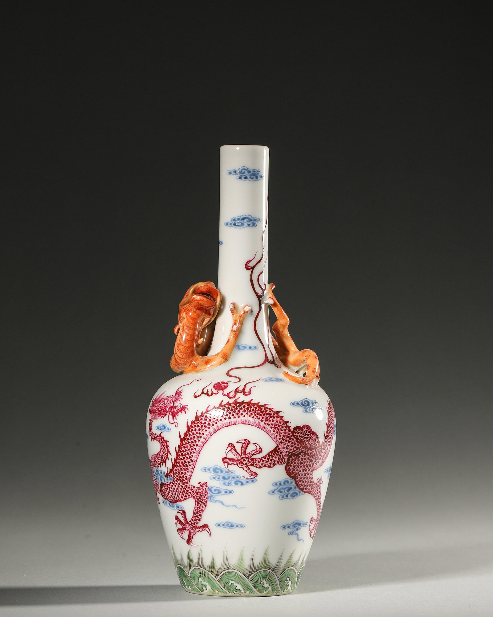 A BLUE-AND-WHITE AND IRON-RED 'DRAGON' PORCELAIN VASE: A blue-and-white porcelain vase decorated with an iron-red dragon. Diam. 9 cm; Ht. 19.5 cm.