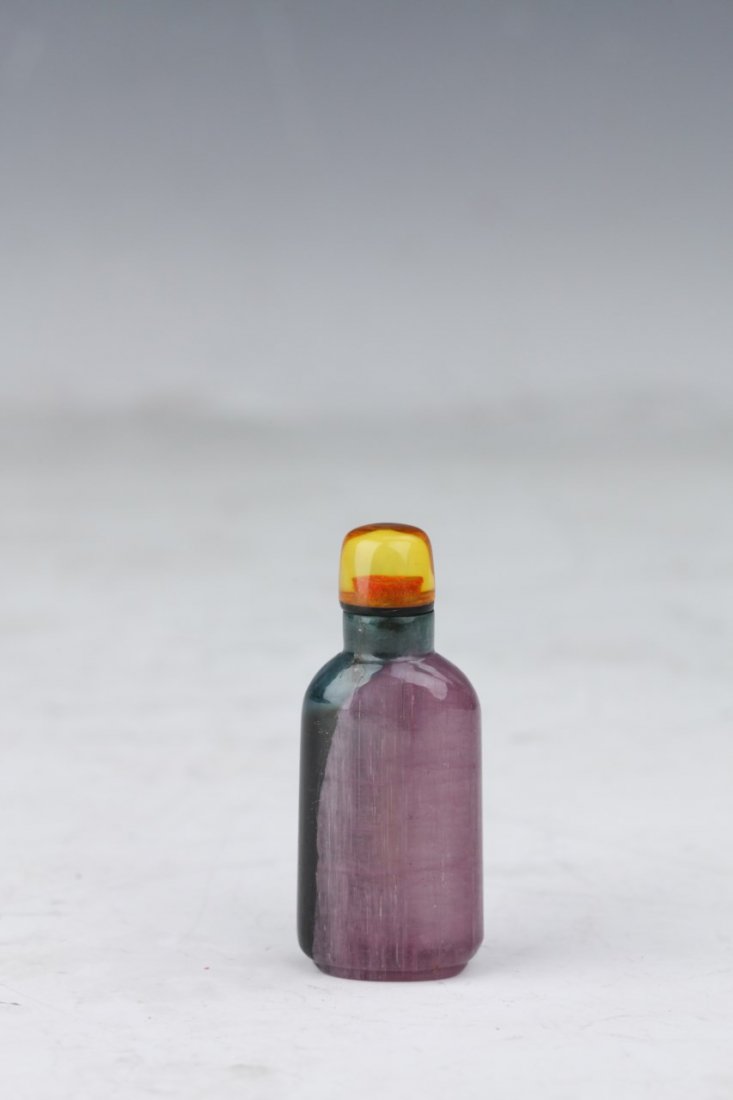Tourmaline Snuff Bottle: Tourmaline snuff bottle in shades of pink and blue featuring a translucent amber-gold cap. Remarkable luminescence. Height 2.75"
