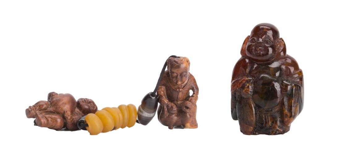 Group of Three Carved netsuke: Group of three carved netsuke, of two wood carved figures and one Buddha figure. Height 2" (Tallest)