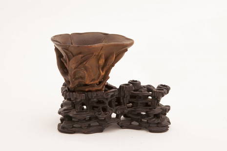 Carved Agar wood cup with wood stand: Rare crafted Agar wood petal shaped cup and carved greenery detailing with meticulously carved wooden stand. Length 4.5" Width 3.5" Height 3"