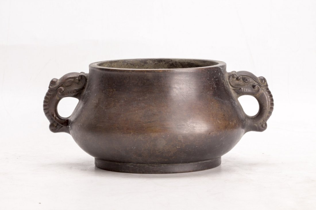 Chinese Bronze censer: Chinese bronze censer, of low squat form, with two dragon head handles, with seal mark. Diameter 5.25" Length 9" Height 4"