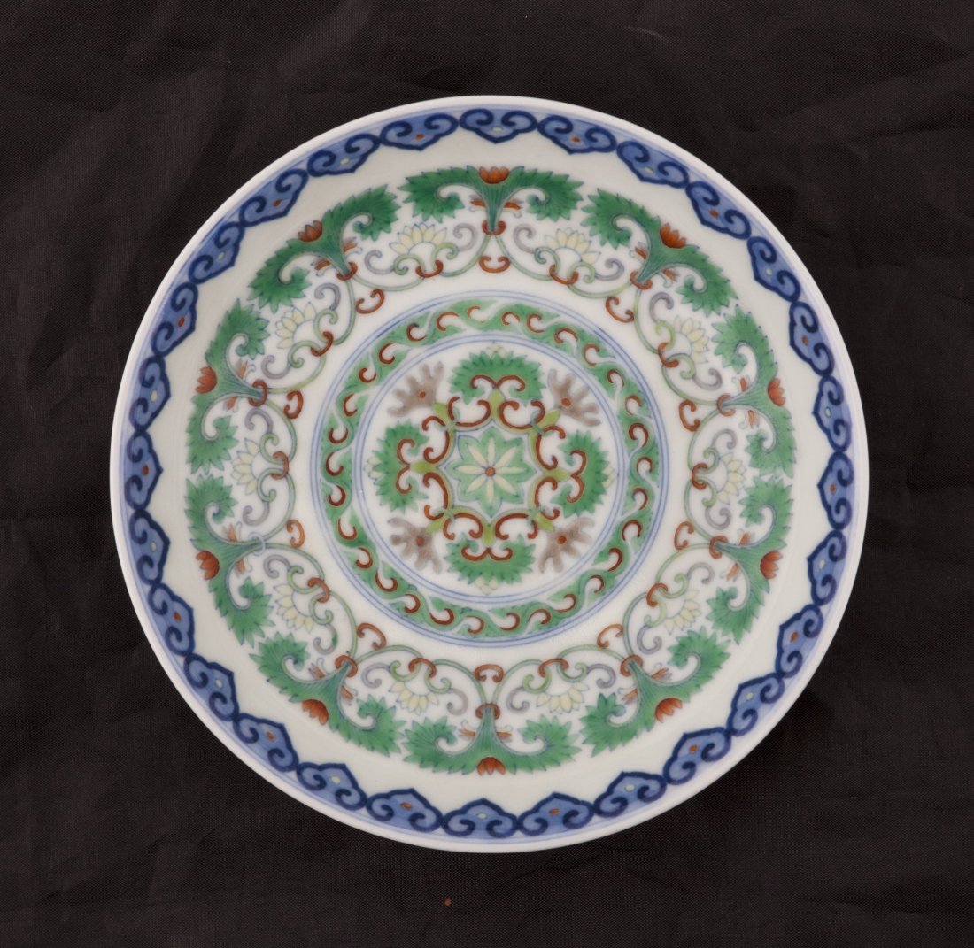Dou Cai porcelain dish: Exquisite Dou Cai porcelain dish on Lucite stand with elaborate pattern of lotus blossoms and auspicious detailing. Inner rim and outer base features a colorful Ryu Yi pattern. Qianlong imprint seal o