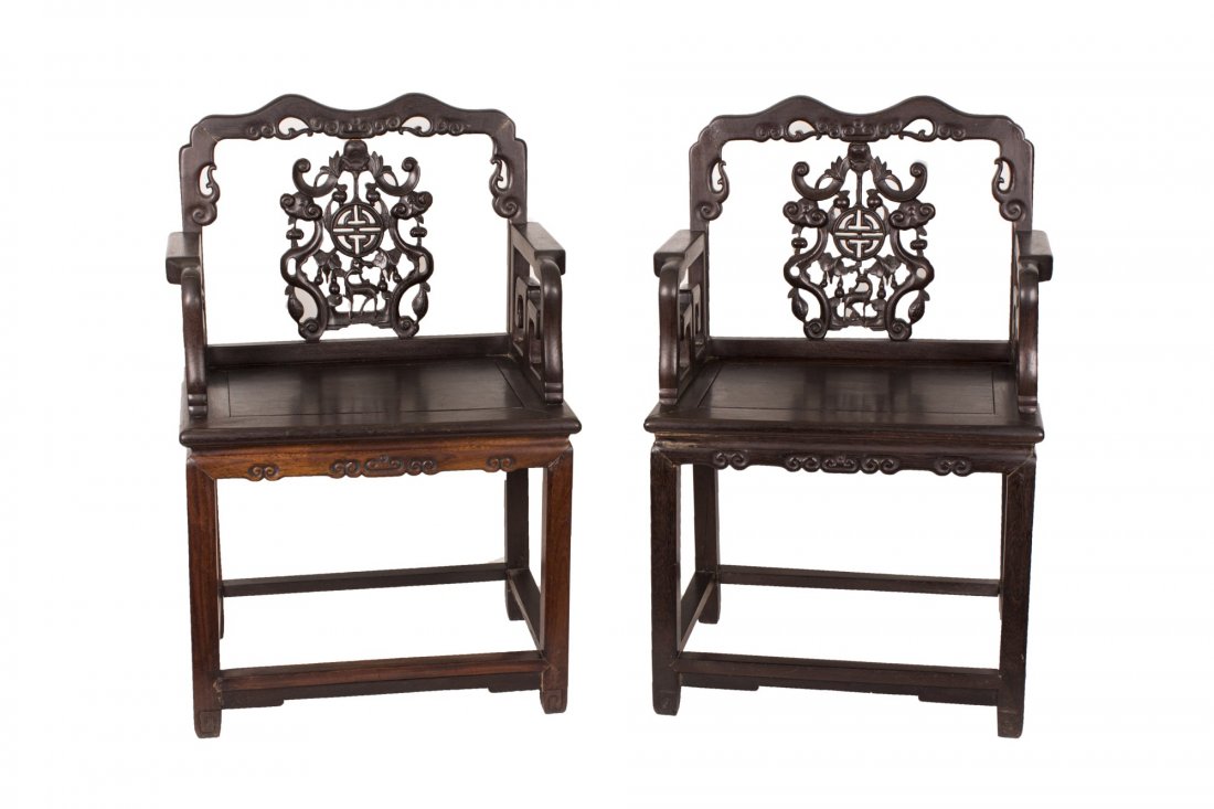 A pair of Hardwood Or Ji Chi wood chair: A pair of Hardwood Or Ji Chi wood chair, each of square shape and dark brown color, with exquisitely shaped top rail and hollowed escutcheon splat back with intricate patterns, feet united by square s