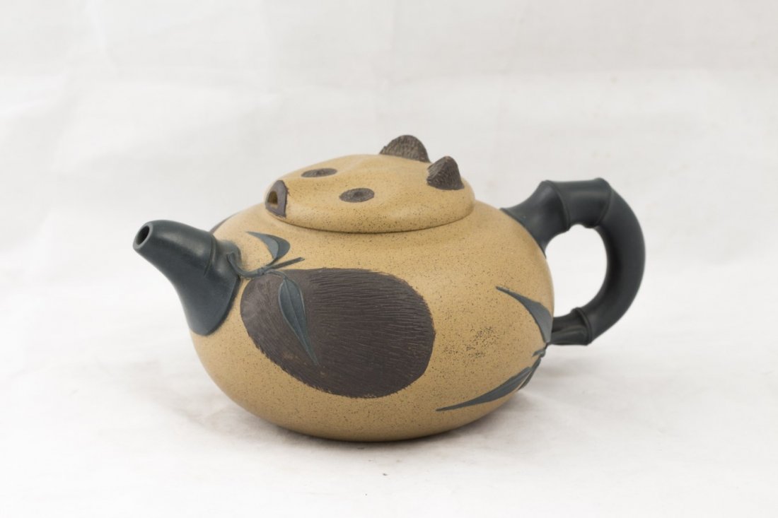 Chinese Yixing Clay Teapot: Chinese Yixing clay teapot, hand painted with adorable panda face on the lid, design with bamboo motif on the handle and mouth, artist name under the teapot. Diameter 4.5" Length 6.75"