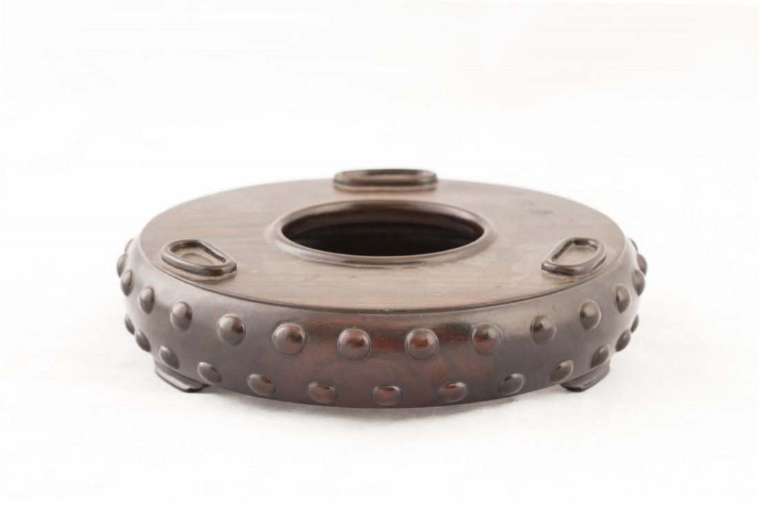 A Chinese Drum-like Rosewood Stand: A Chinese Drum-like Rosewood Stand, designed with a center opening inside-out, probably a tripod holder. Diameter 1.5" Height 1.5"