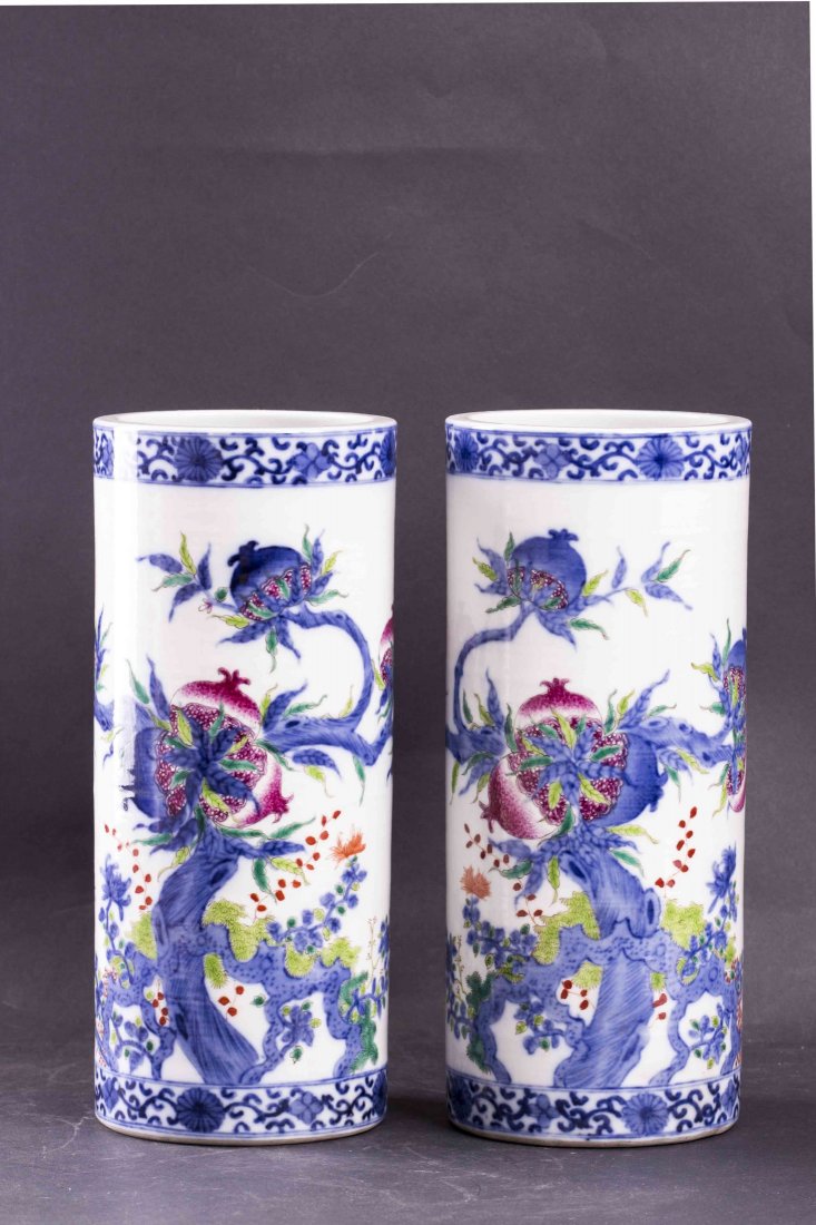 Pair of Chinese Dou Cai Porcelain Incense Holder: A pair of Chinese Dou Cai porcelain incense holder, of slim cylindrical form, each with the design of blooming pomegranates against blue and white design on white ground, framed by a floral border. Di