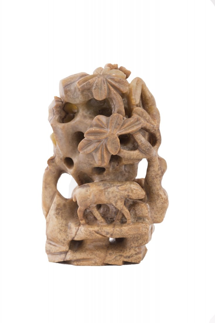 Chinese Liao Jin Style Mountain Sculpture: A Liao Jin style elaborately openwork carved statue, of rock work and tree with an animal walking on the base on the bottom center, of yellowish coloration. Length 2.5" Width 2" Height 4"