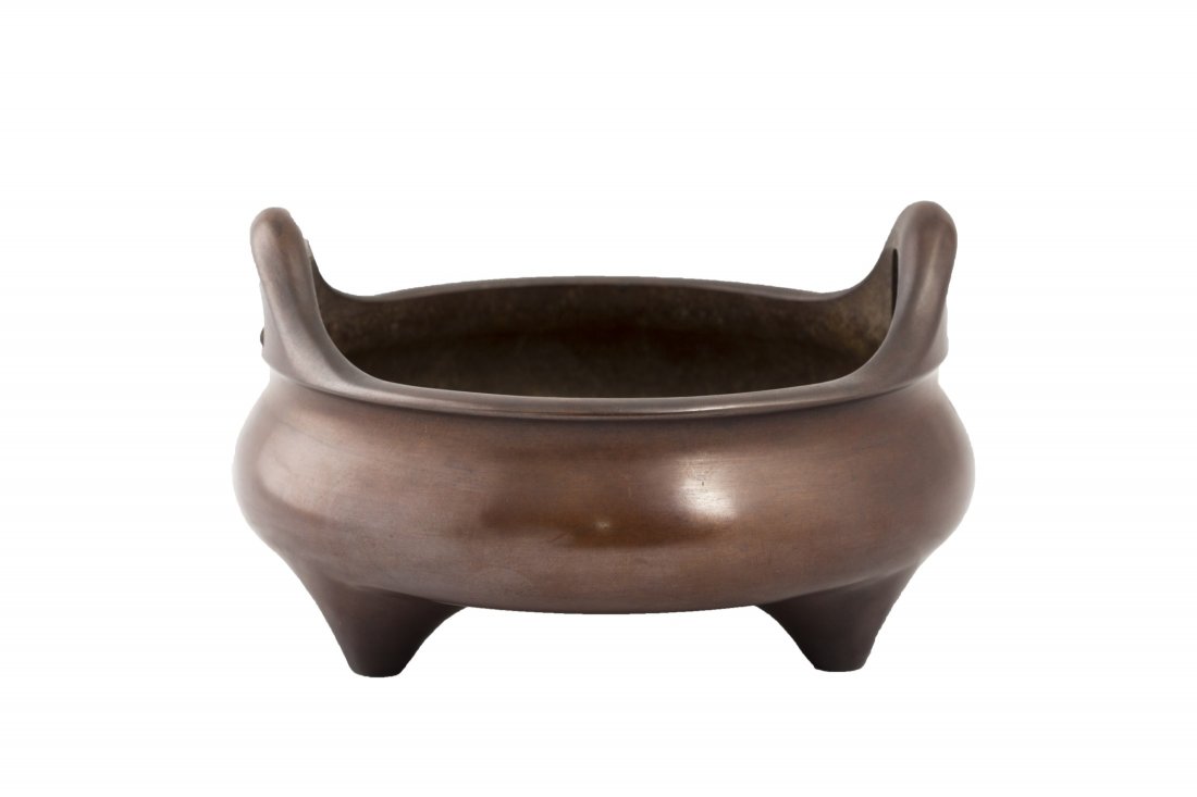 Chinese Bronze Incense Burner: Chinese bronze incense burner, of triopd form, with two symmetrical upright loop handles to the side. Diameter 6.25" Height 4"