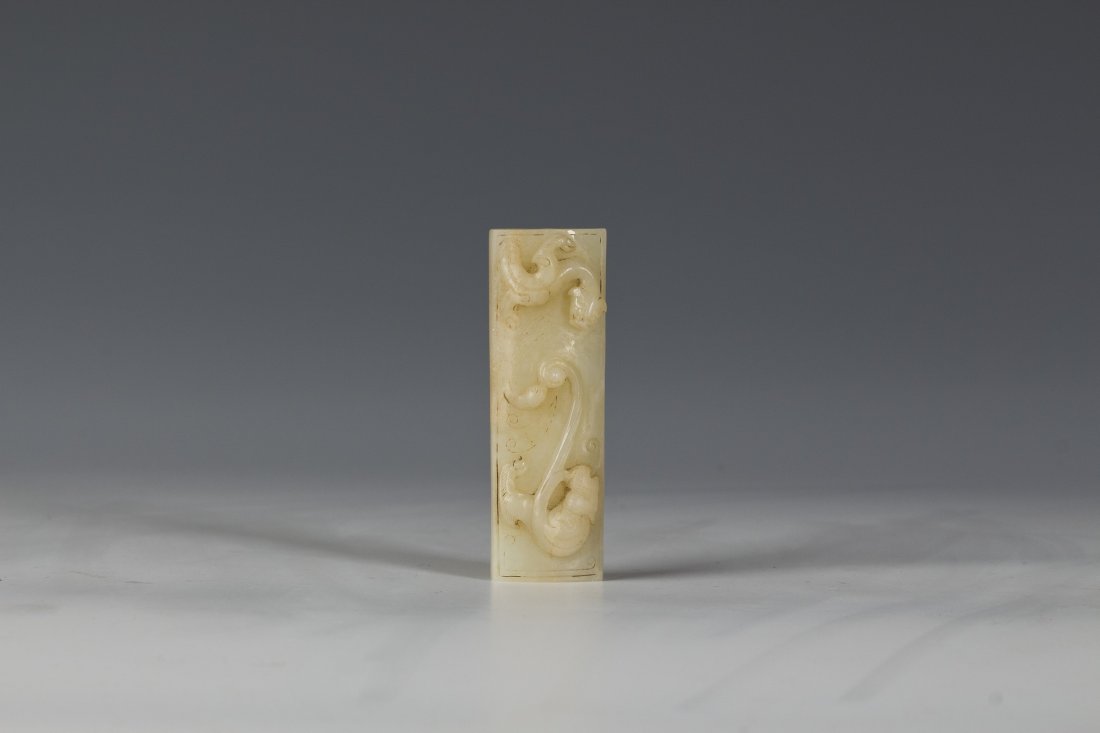 Chinese Warring Style Jade Ornament: Chinese Warring-style Jade Ornament. One side has high-raised relief of two beasts facing each other while the other side has warring-style pattern. Length 2.75" Width 1" Height 0.25"