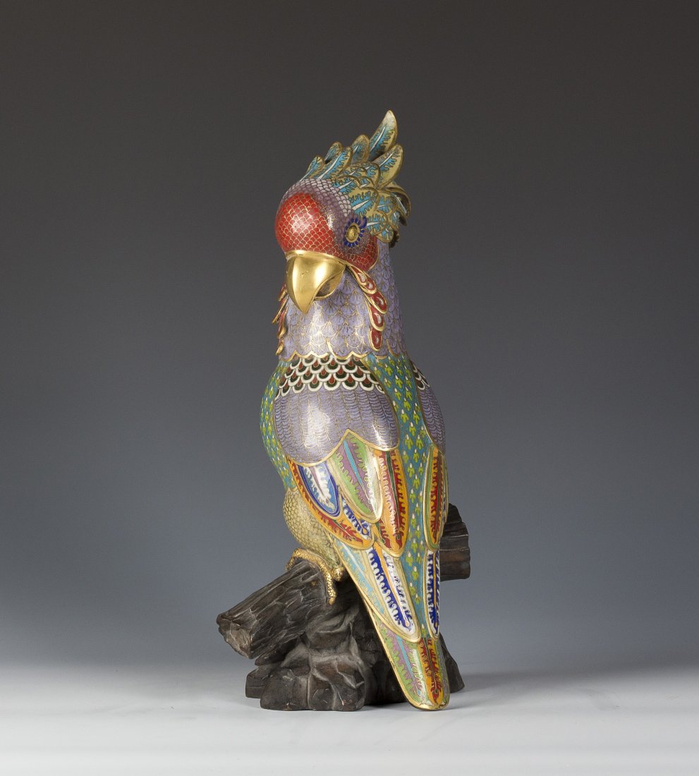 Cloisonne Parrot Statue: Cloisonne Parrot Statue standing on a segment of tree trunk. The parrot has exquisite detail and vivid colors. Length 6" Width 8" Height 16"