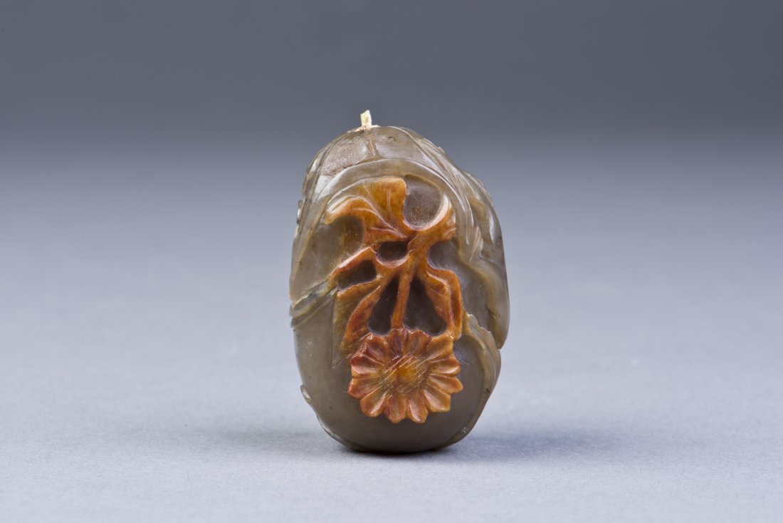 Soapstone Snuff Bottle: A Soapstone Snuff Bottle carved with monkey and orange foliage relief. Height 2'' Diameter 1''