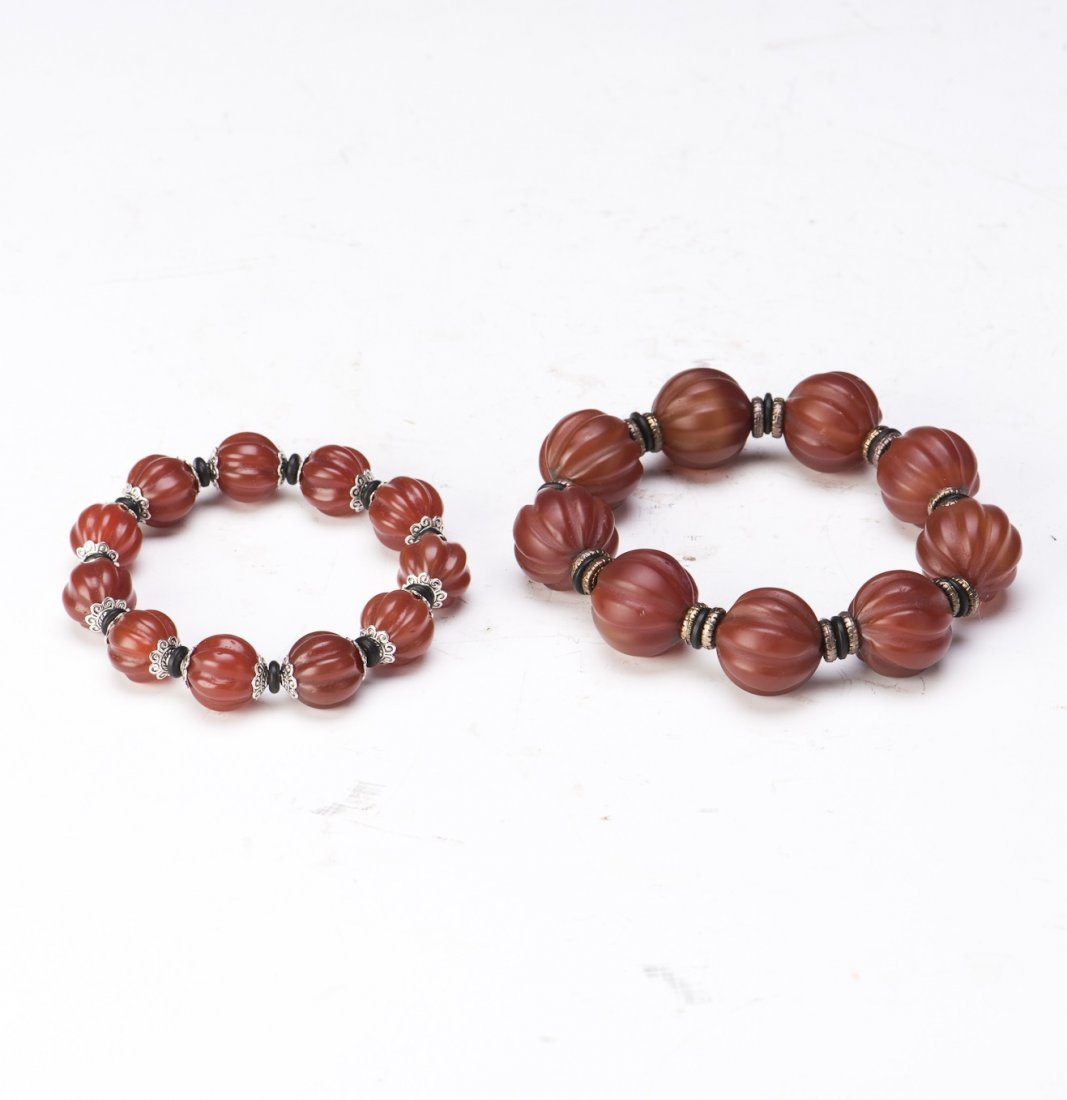 TWO AGATE BRACELETS: Two agate bracelets of different sizes and metal spacer beads. Diameter 3.5" Bead 0.5"; Diameter 3" Bead 0.25"