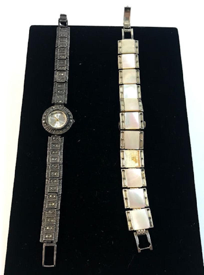 TWO VINTAGE WRIST WATCHES ~ STERLING/MARCASITE BAND: TWO VINTAGE WRIST WATCHES ~ STERLING/MARCASITE BAND WRIST WATCH W/JAPANESEMADE QUARTZ MOVEMENT AND NO JEWELS. 1.04 TROY OUNCES TW. MOTHER-OF-PEARL LINKWATCH W/CLEAR DIAMANTE STONE BAGUETTE ACCENTS FRO