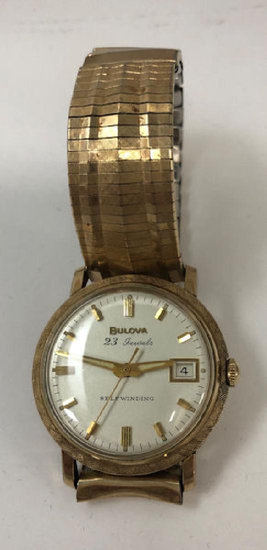 BULOVA WRIST WATCH ~ 23-JEWEL MOVEMENT. SELF-WINDING.: BULOVA WRIST WATCH ~ 23-JEWEL MOVEMENT. SELF-WINDING. GOLD TONE STETCHBAND/CASE (10KT RGP). TAPERED GOLD TONE HANDS/INDICATORS. DATE MOVEMENT ON FACE.NUMBERED K49498.