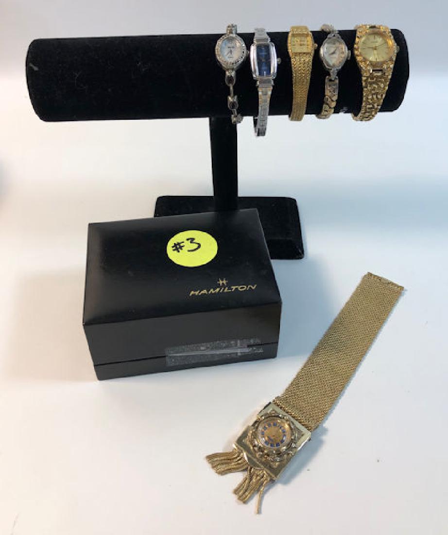 LOT OF SIX WRIST WATCHES ~ W/HINGED BLACK BRANDED: LOT OF SIX WRIST WATCHES ~ W/HINGED BLACK BRANDED HAMILTON BOX. WATCHESINCLUDE: GOLD TONE NUGGET STYLE WATCH FROM GRUEN W/QUARTZ MOVEMENT, GOLDTONE MESH BAND WATCH FROM HELBROS W/POLISHED FINISH, GOLD