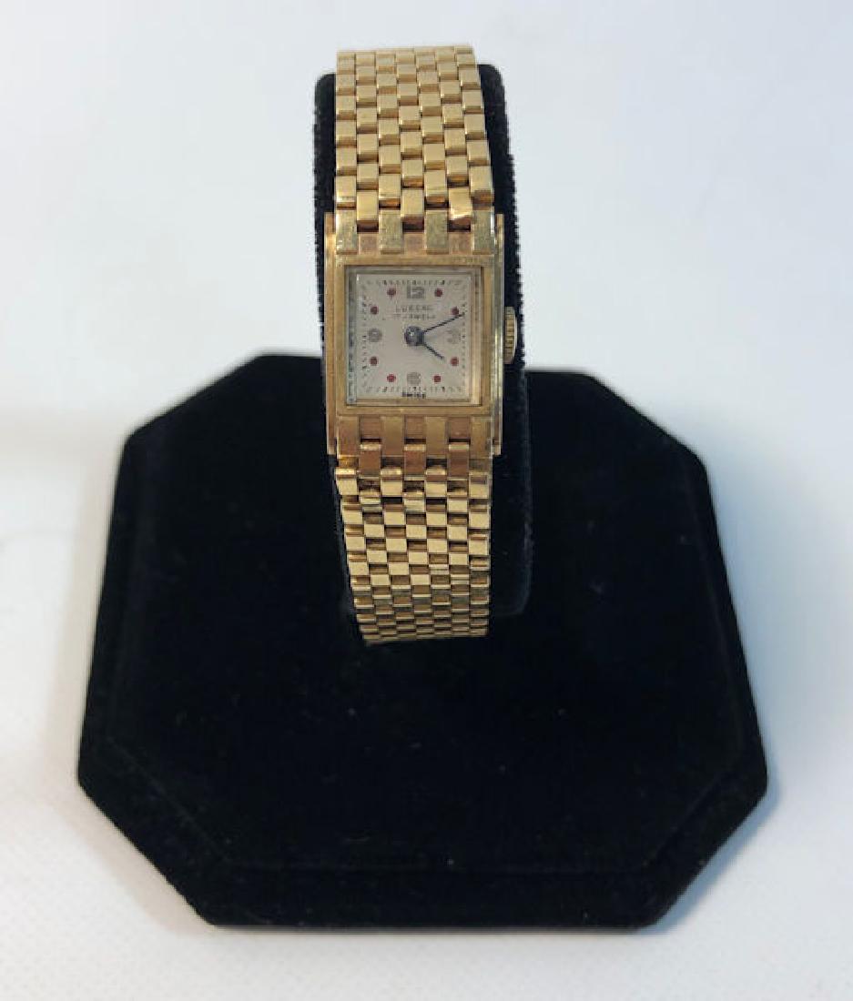 14KT YELLOW GOLD WRIST WATCH ~ VINTAGE STYLE FROM: 14KT YELLOW GOLD WRIST WATCH ~ VINTAGE STYLE FROM LUSSAC, 17 JEWEL MOVEMENT,FOLDOVER CLASP RED INDICATORS ON OFF WHITE FACE, SERIAL NUMBER "7318811" (34.7 GTW)