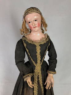 25&frac12;" EARLY ANTIQUE WOODEN "CAGE DOLL" IN EARLY: 25&frac12;" EARLY ANTIQUE WOODEN "CAGE DOLL" IN EARLY COSTUME. SCULPTED AND PAINTED COMPOSITION LAYER OVER WOOD SHOULDER HEAD WITH GLASS EYES AND PAINTED FACIAL FEATURES. TORSO, ARMS, HANDS AND "CAGE"