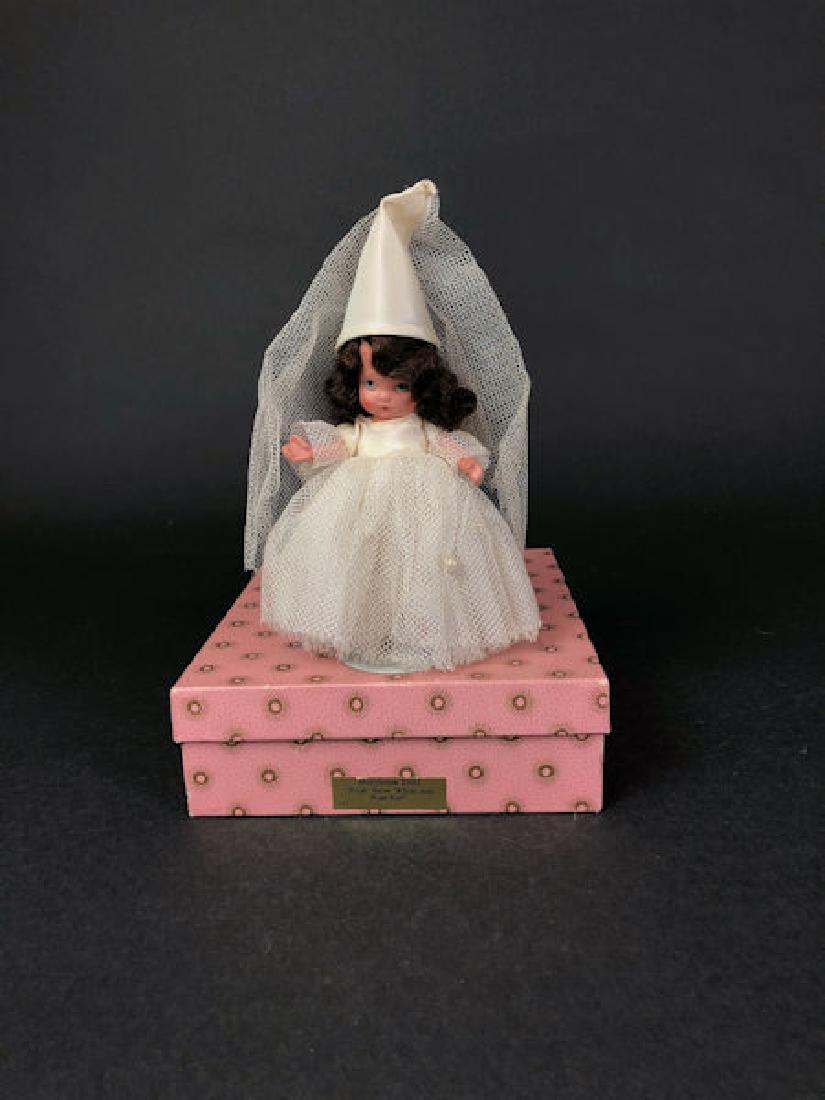 5" JUDY ANN STORYBOOK DOLL IN ORIGINAL COSTUME AND PINK: 5" JUDY ANN STORYBOOK DOLL IN ORIGINAL COSTUME AND PINK SUNBURST BOX. "JUDY ANN USA" MARK ON JOINTED PT BISQUE BODY, MOLDED SOCKS, MOLDED BANGS AND PAINTED SILVER SHOES. HAS THE THREE PEARLS SEWN TO T