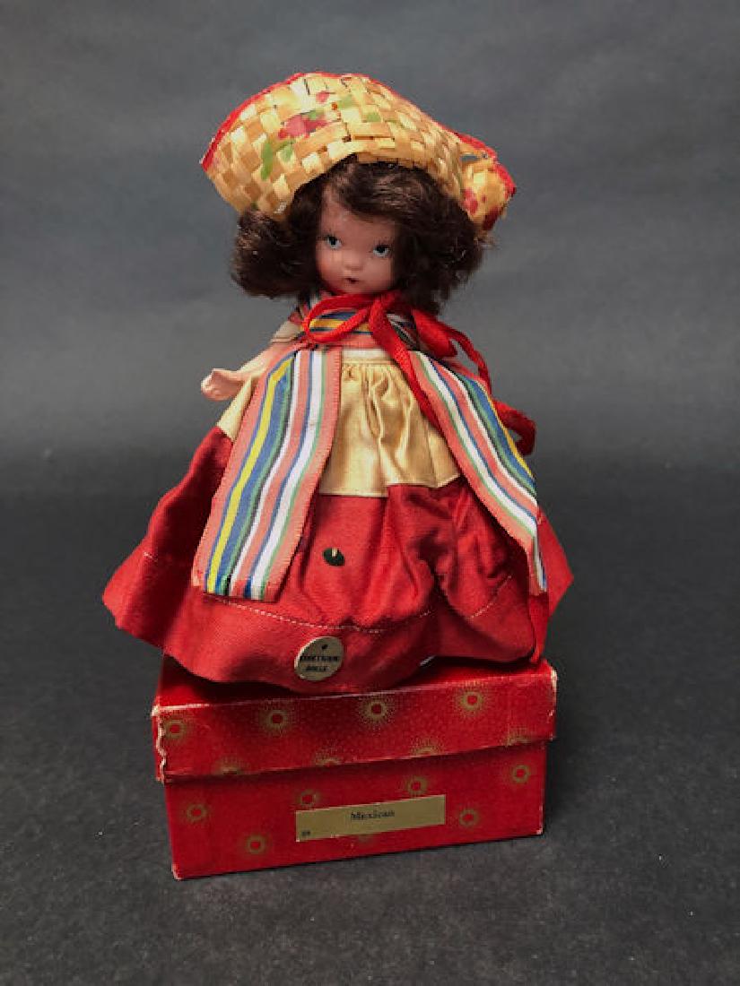 5¼" JUDY ANN STORYBOOK DOLL IN ORIGINAL COSTUME: 5¼" JUDY ANN STORYBOOK DOLL IN ORIGINAL COSTUME AND RED SUNBURST BOX. "JUDY ANN USA" MARK ON JOINTED PT BISQUE BODY, MOLDED SOCKS, MOLDED BANGS AND PAINTED BLACK SLIPPERS. COMES WITH GOLD FOIL