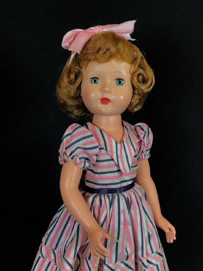 18" VINTAGE HARD PLASTIC EFFANBEE HONEY WALKER IN: 18" VINTAGE HARD PLASTIC EFFANBEE HONEY WALKER IN ORIGINAL OUTFIT. LIGHT BROWN HAIR AND SLEEP EYES WEARING PINK AND BLACK STRIPE DRESS WITH MATCHING PANTY, ORIGINAL BLACK SHOES AND WHITE SOCKS. HAS OR