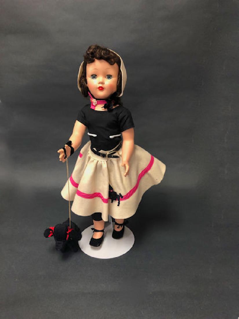 25" VINTAGE EFFANBEE HARD PLASTIC HONEY WALKER DOLL IN: 25" VINTAGE EFFANBEE HARD PLASTIC HONEY WALKER DOLL IN ORIGINAL FELT POODLE SKIRT OUTFIT. SHE IS WALKING HER LITTLE BLACK POODLE.