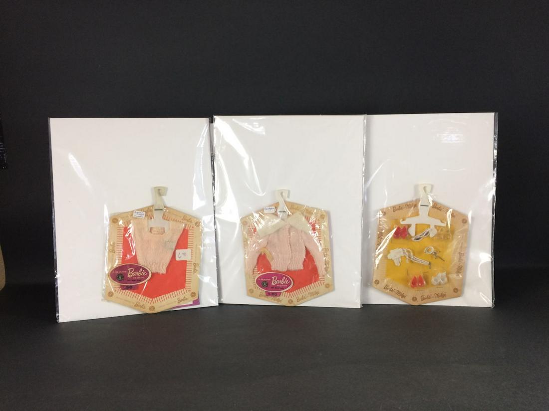 3 FASHION PAKS FOR BARBIE AND MIDGE INCLUDING "SQUARE: 3 FASHION PAKS FOR BARBIE AND MIDGE INCLUDING "SQUARE NECK SWEATER" (PINK), "CARDIGAN" (PINK), AND "ACCESSORY PAK". NONE HAVE BEEN REMOVED FROM ORIGINAL PACKAGING, ALL HAVE FADING TO CARDBOARD WITH SO