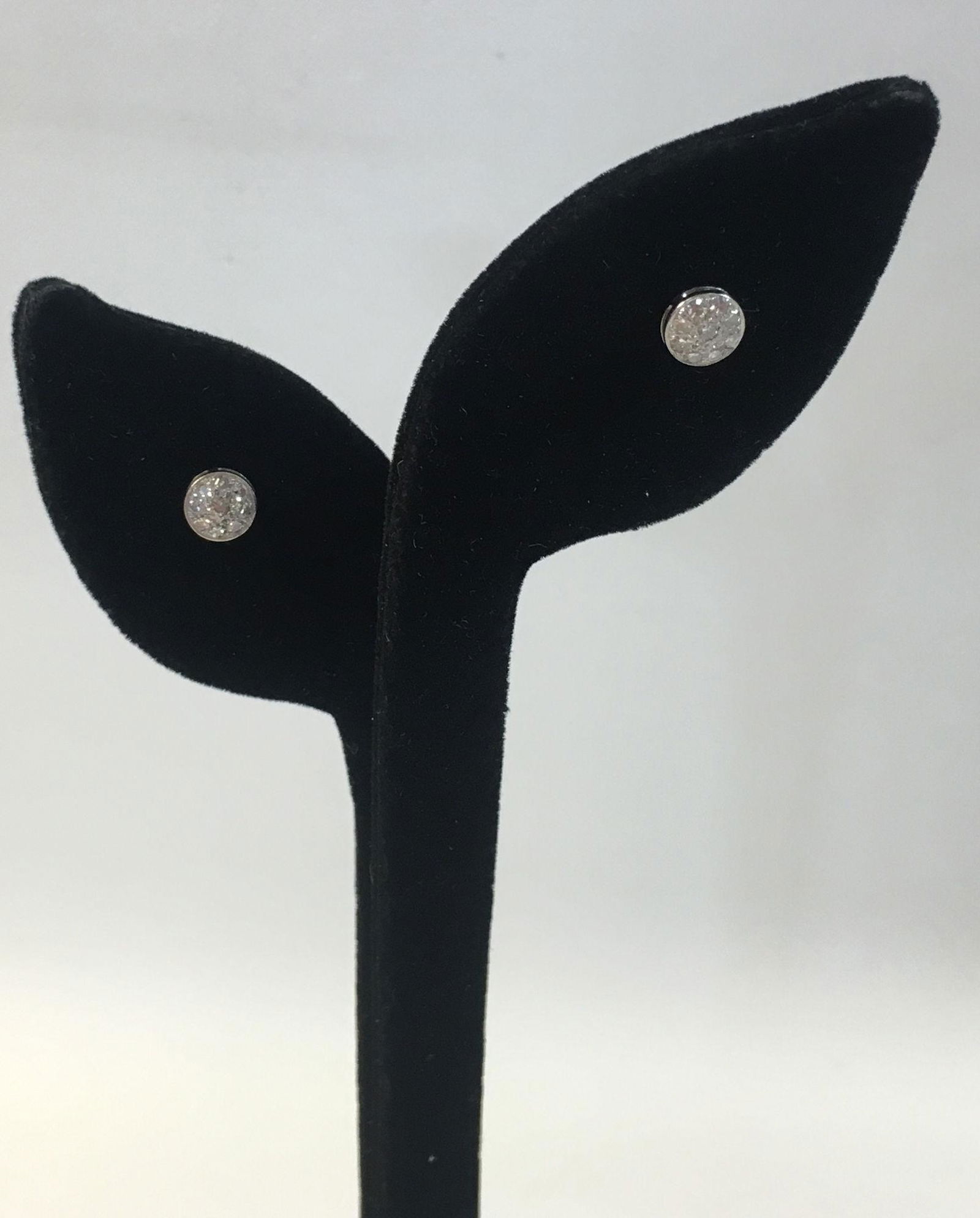 DIAMOND EARRINGS: DIAMOND EARRINGS ~ EACH W/NINE SMALL MELEE SIZE DIAMONDS IN CLUSTERED MOUNT. POST BACKS. POLISHED 14KT WHITE GOLD SETTINGS. APPROXIMATELY 0.28 CTTW. 1.4 GRAMS TW.