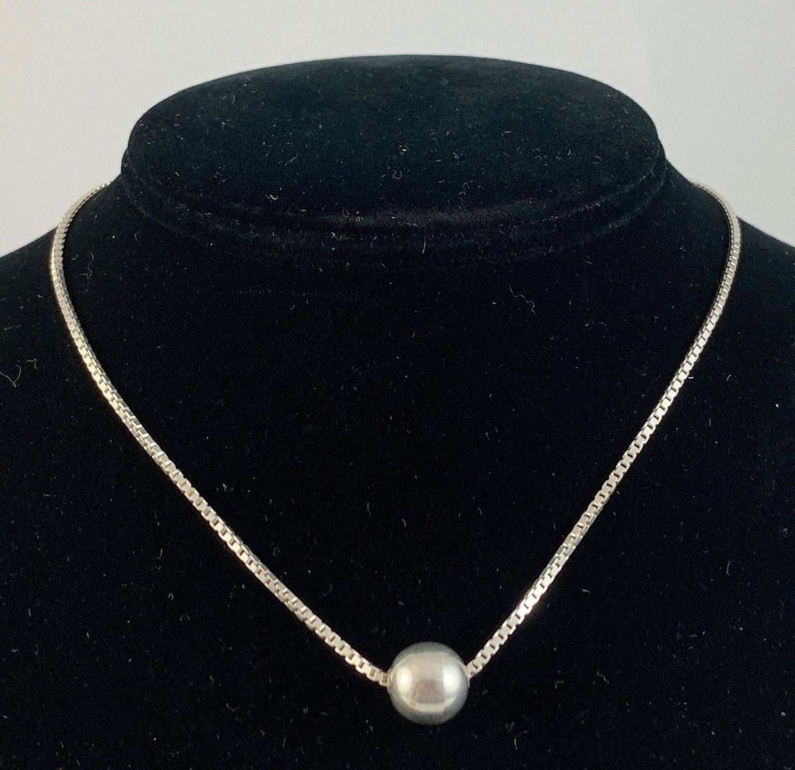 STERLING BOX CHAIN NECKLACE: STERLING BOX CHAIN NECKLACE ~ 14" CHOKER LENGTH. POLISHED FINISH. ITALIAN MADE W/SPRING RING CLASP CLOSURE. 0.205 TROY OUNCES TW. STERLING SLIDE PENDANT (BALL).
