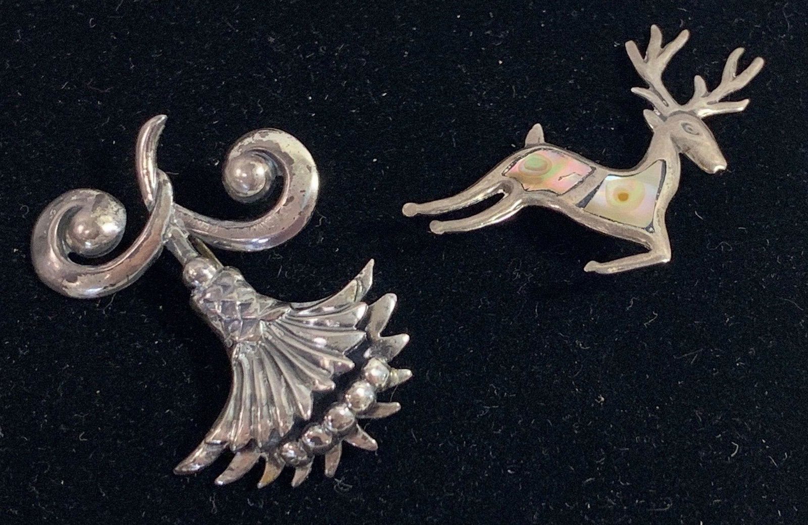TWO SILVER PINS: TWO SILVER PINS ~ STERLING SILVER STYLES. 1" AND 1.25" STYLES. FLORAL PIN W/HIGH POLISH FINISH. DEER PIN W/INLAID ABALONE. 0.315 TROY OUNCES TW.
