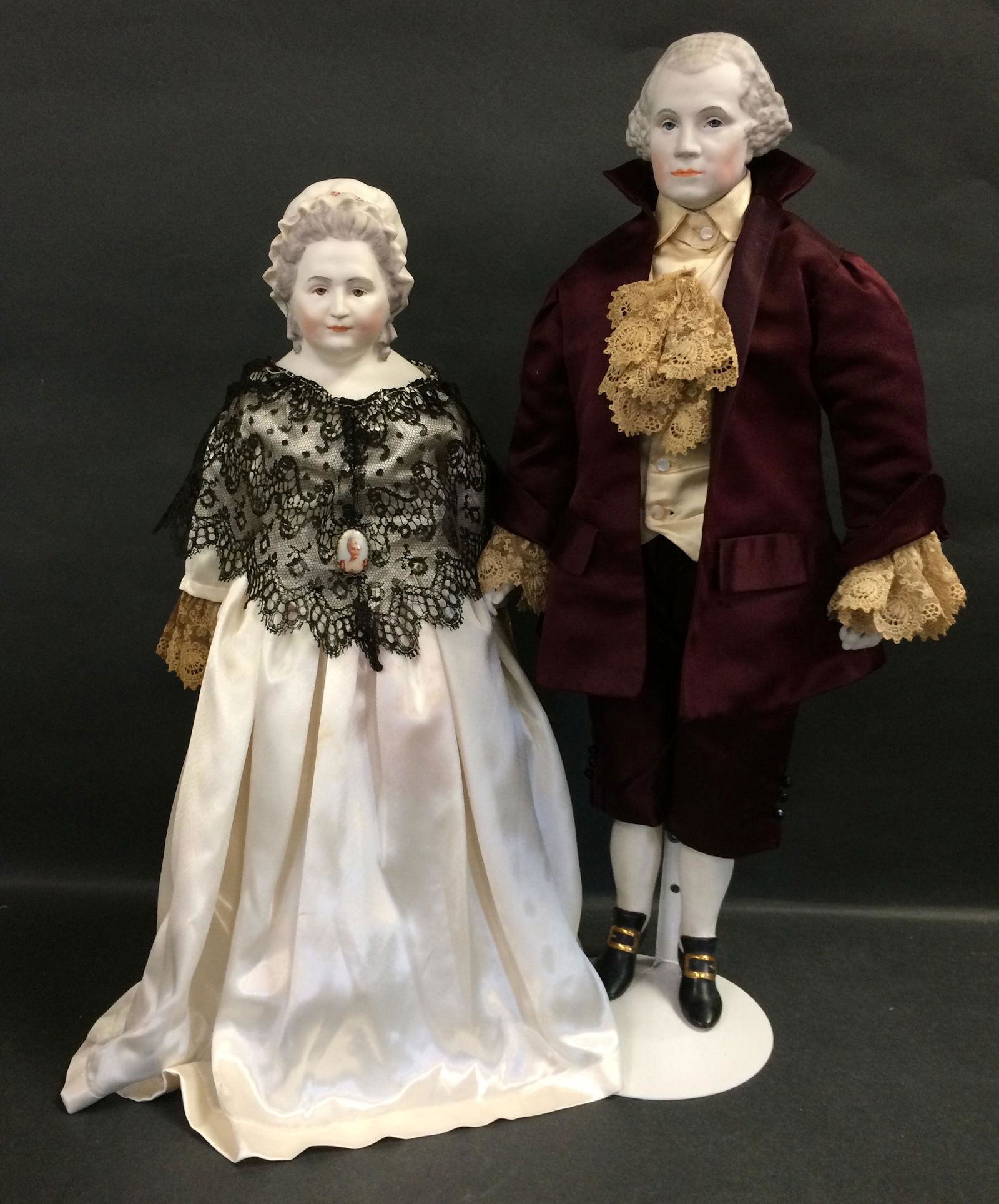 GEORGE AND MARTHA WASHINGTON BY EMMA CLEAR. GEORGE IS: GEORGE AND MARTHA WASHINGTON BY EMMA CLEAR. GEORGE IS 21 1/2" WITH MOLDED AND PAINTED BISQUE SHOULDER HEAD, CLOTH BODY WITH BISQUE LOWER ARMS AND LEGS, MOLDED AND PAINTED SHOES AND STOCKINGS. MARTHA I