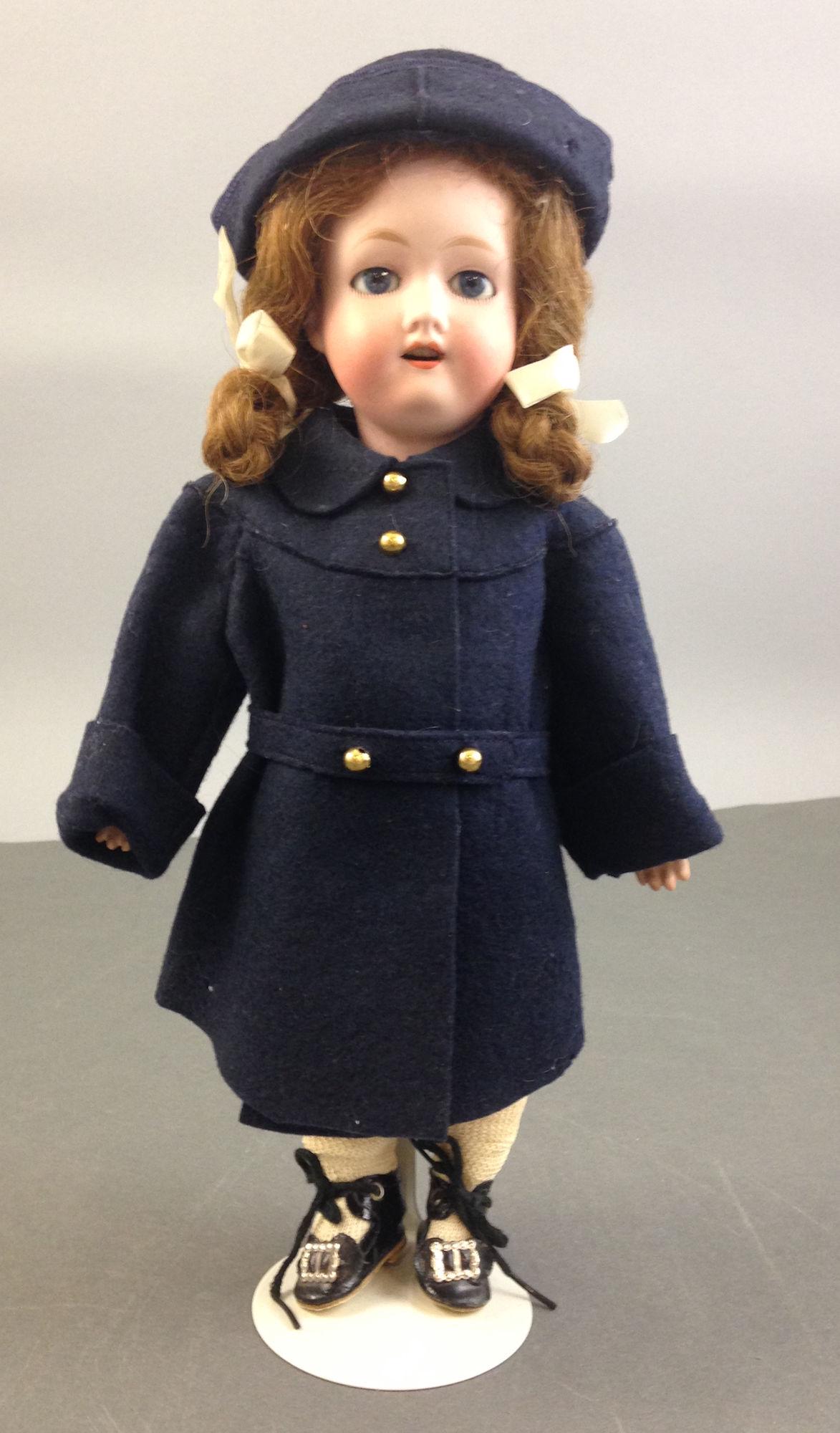 13" MORIMURA BROS. BISQUE SOCKET HEAD GIRL. GLASS SLEEP: 13" MORIMURA BROS. BISQUE SOCKET HEAD GIRL. GLASS SLEEP EYES, HUMAN HAIR WIG, OPEN MOUTH WITH TEETH, ON JOINTED COMPOSITION BODY. COAT RETAINS MARSHALL FIELD & COMPANY PRICE TAG.
