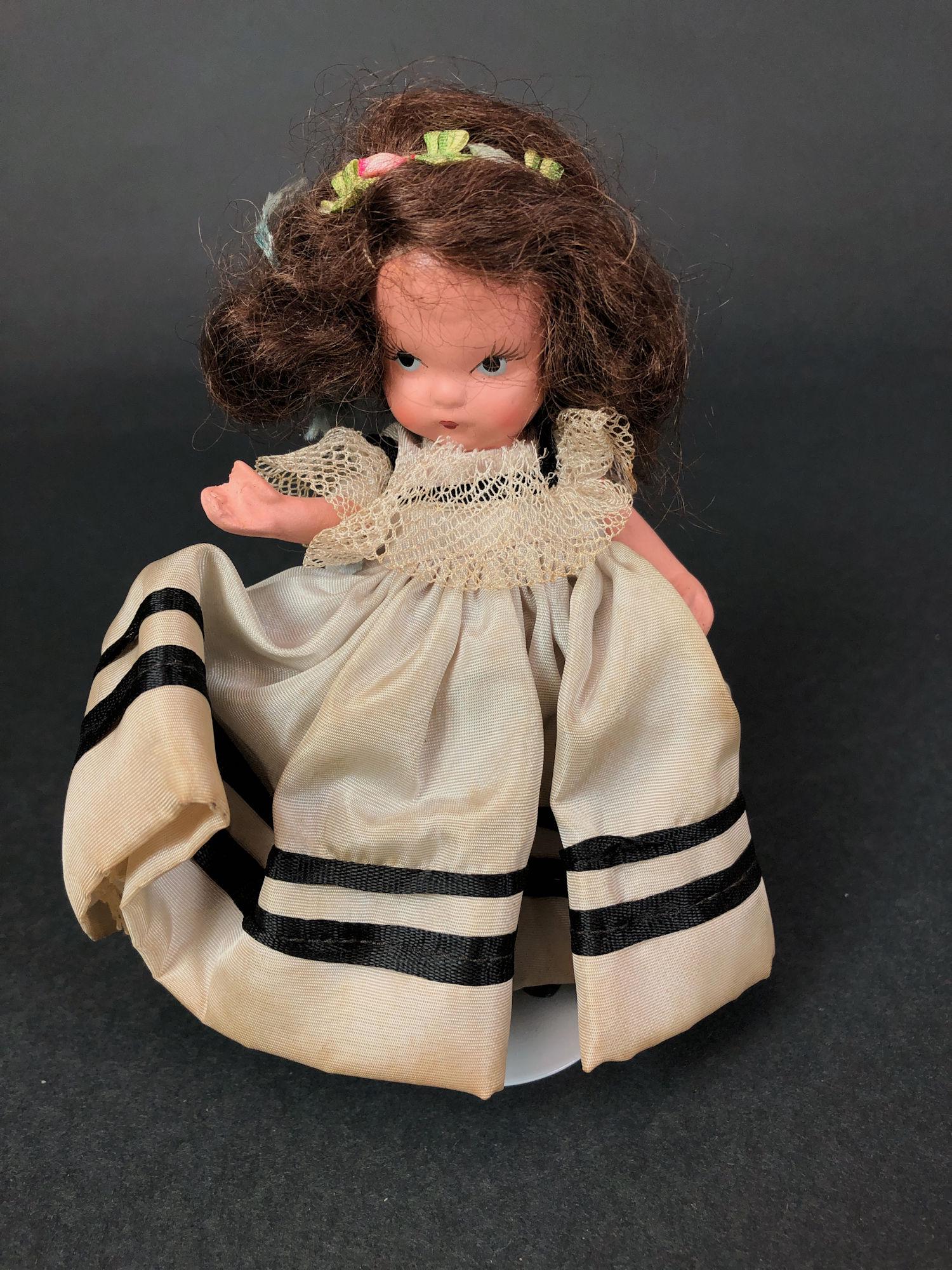 5¼" JUDY ANN STORYBOOK DOLL IN ORIGINAL COSTUME: 5¼" JUDY ANN STORYBOOK DOLL IN ORIGINAL COSTUME AND PALE BLUE SUNBURST BOX. "JUDY ANN USA" MARK ON JOINTED PT BISQUE BODY, MOLDED SOCKS, MOLDED BANGS AND GOLD FOIL LABEL ON BOX. "AMERICAN GIRL