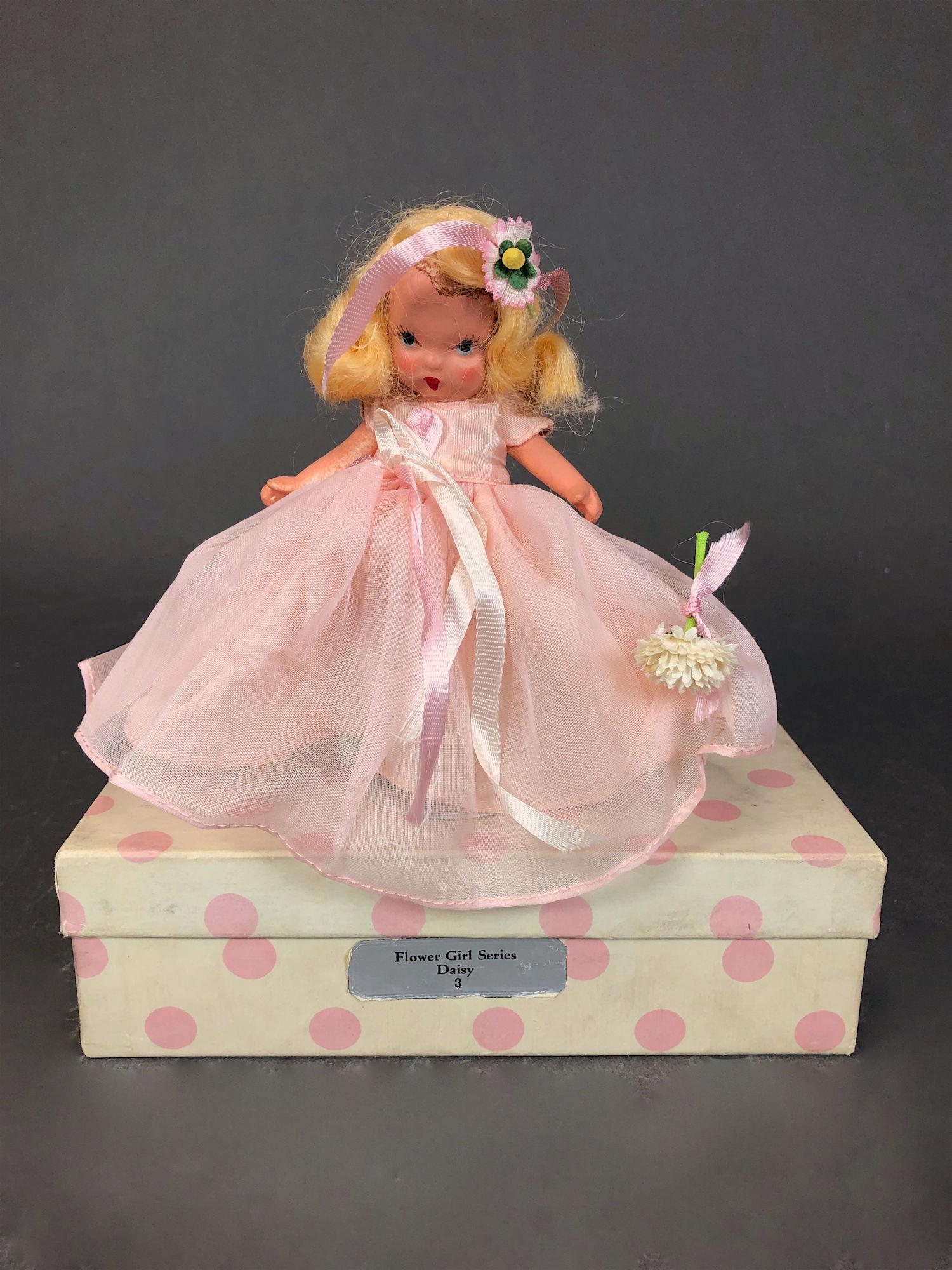 5" STORYBOOK DOLL IN ORIGINAL COSTUME. "STORYBOOK DOLL: 5" STORYBOOK DOLL IN ORIGINAL COSTUME. "STORYBOOK DOLL USA" MARK ON JOINTED PT BISQUE BODY, GOLD FOIL WRIST TAG, "STORYBOOK DOLLS" "DAISY" AND PAINTED BLACK SLIPPERS. COMES WITH WHITE BOX/PINK DOTS AN