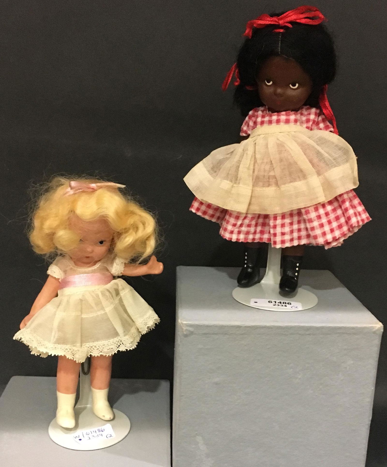 (2) 5¼" JUDY ANN STORYBOOK DOLLS "TOPSY AND: (2) 5¼" JUDY ANN STORYBOOK DOLLS "TOPSY AND EVA" #176 IN ORIGINAL COSTUMES. BOTH HAVE "JUDY ANN USA" MARK ON JOINTED PT BISQUE BODY WITH MOLDED SOCKS/BANGS. CUTE PAIR!