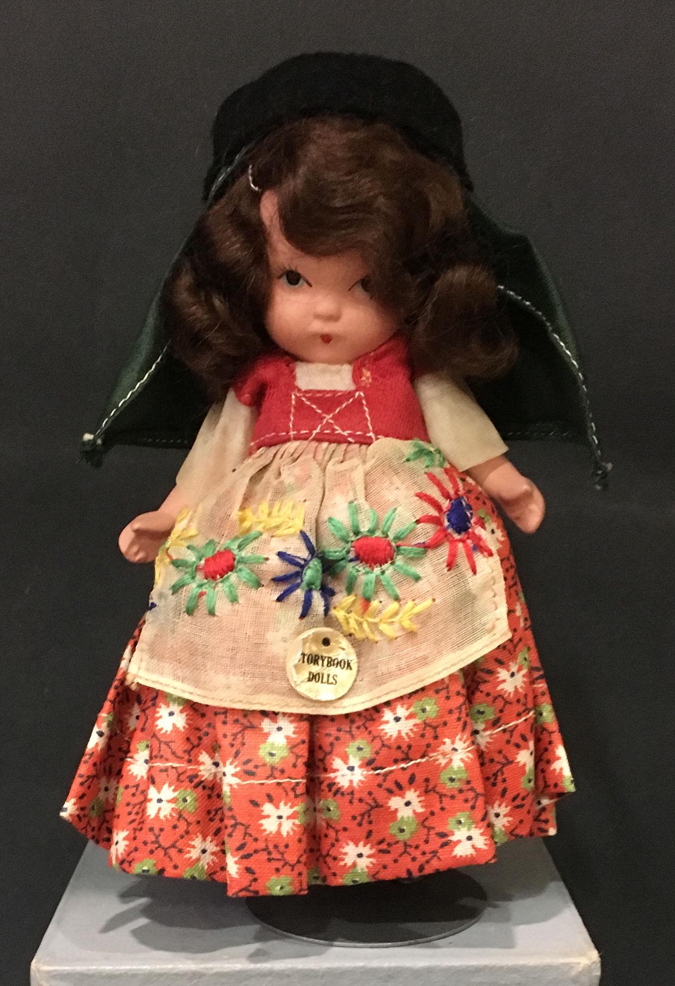 5½" STORYBOOK DOLL IN ORIGINAL COSTUME. "STORY: 5½" STORYBOOK DOLL IN ORIGINAL COSTUME. "STORY BOOK DOLL USA" MARK ON JOINTED PT BISQUE BODY, "PORTUGUESE #31" WITH MOLDED SOCKS/BANGS AND GOLD FOIL TAG "STORYBOOK DOLLS" ON COSTUME.