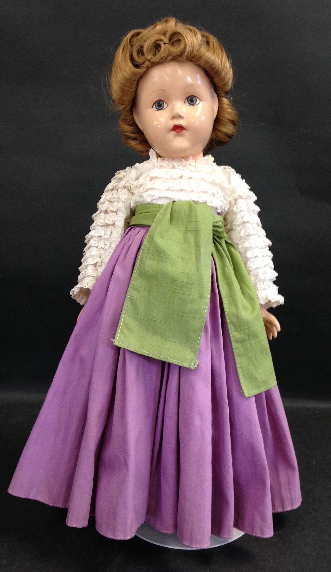 15" EFFANBEE COMPOSITION HISTORICAL DOLL "1939-TODAY".: 15" EFFANBEE COMPOSITION HISTORICAL DOLL "1939-TODAY". ALL ORIGINAL WITH PAINTED EYES AND FACIAL FEATURES, HUMAN HAIR WIG, DOLL SIZE VERSION OF CHANEL'S GYPSY DRESS WITH LAYERED LACE BLOUSE, LONG PURP
