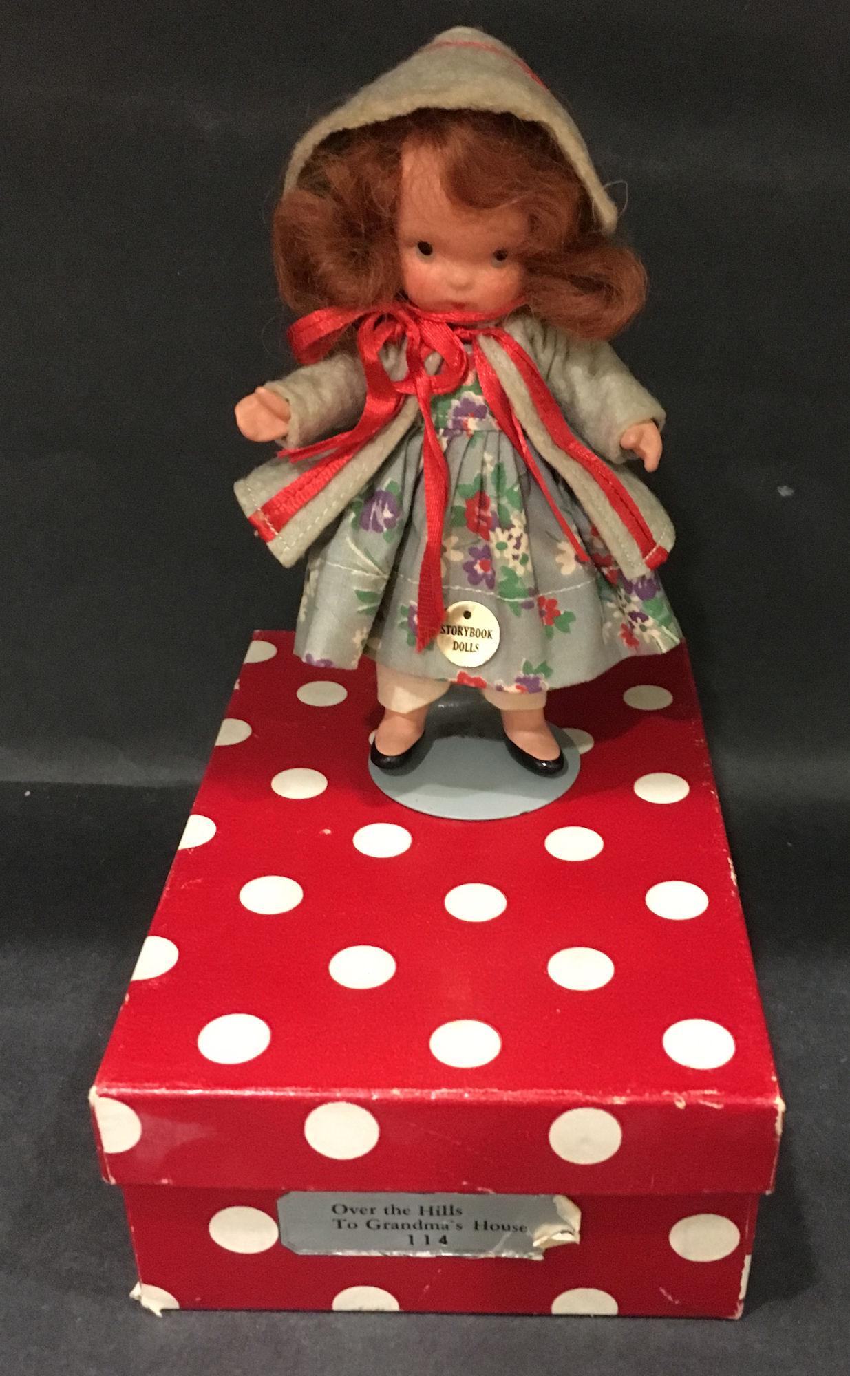 5½" STORYBOOK DOLL IN ORIGINAL COSTUME "OVER THE: 5½" STORYBOOK DOLL IN ORIGINAL COSTUME "OVER THE HILL TO GRANDMA'S HOUSE". "STORYBOOK DOLL USA" MARK ON JOINTED PT BISQUE BODY WITH MOLDED SOCKS AND GOLD FOIL COSTUME STICKER "STORYBOOK DOLLS".
