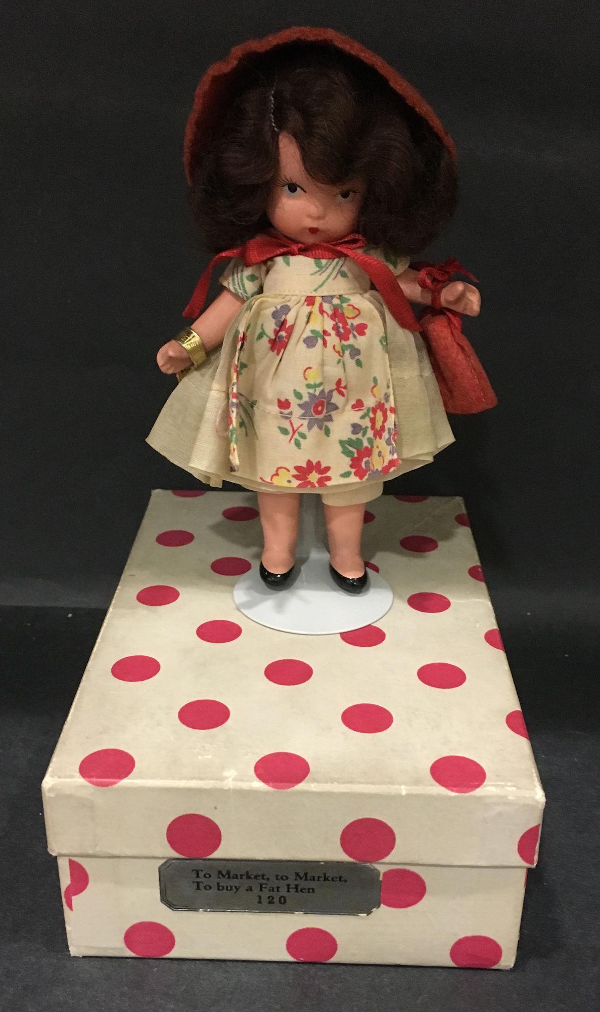 5¼" STORYBOOK DOLL IN ORIGINAL COSTUME "TO: 5¼" STORYBOOK DOLL IN ORIGINAL COSTUME "TO MARKET, TO MARKET, TO BUY A FAT HEN" #120. "STORYBOOK DOLL USA" MARK ON JOINTED PT BISQUE BODY WITH MOLDED SOCKS/BANGS AND GOLD FOIL WRIST TAG "TO MAR