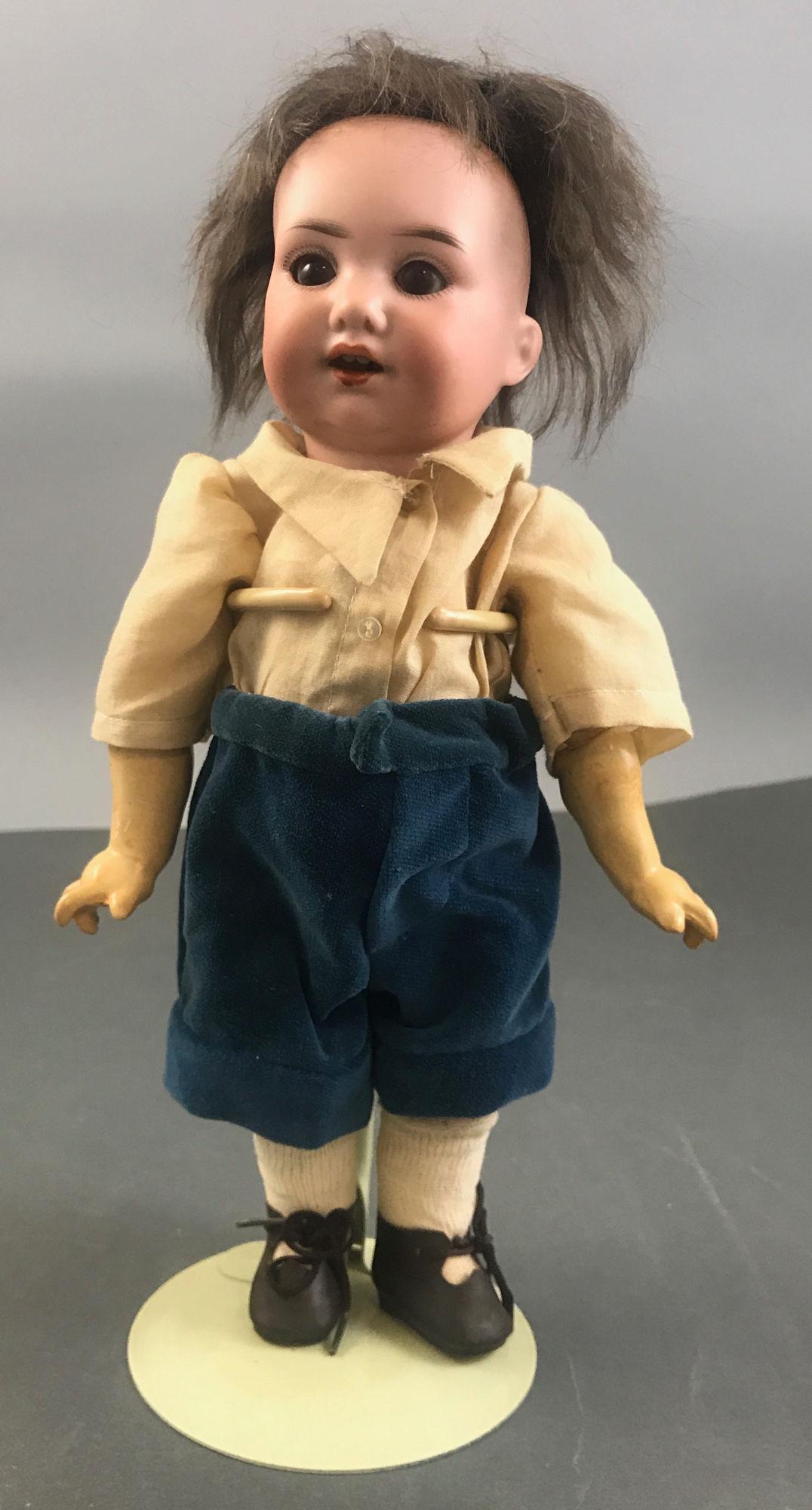 11 1/2" ARMAND MARSEILLE 971 BISQUE SOCKET HEAD: 11 1/2" ARMAND MARSEILLE 971 BISQUE SOCKET HEAD CHARACTER TODDLER. MOHAIR WIG, GLASS SLEEP EYES, OPEN MOUTH WITH TEETH, ON JOINTED COMPOSITION TODDLER BODY WITH STRAIGHT WRISTS.