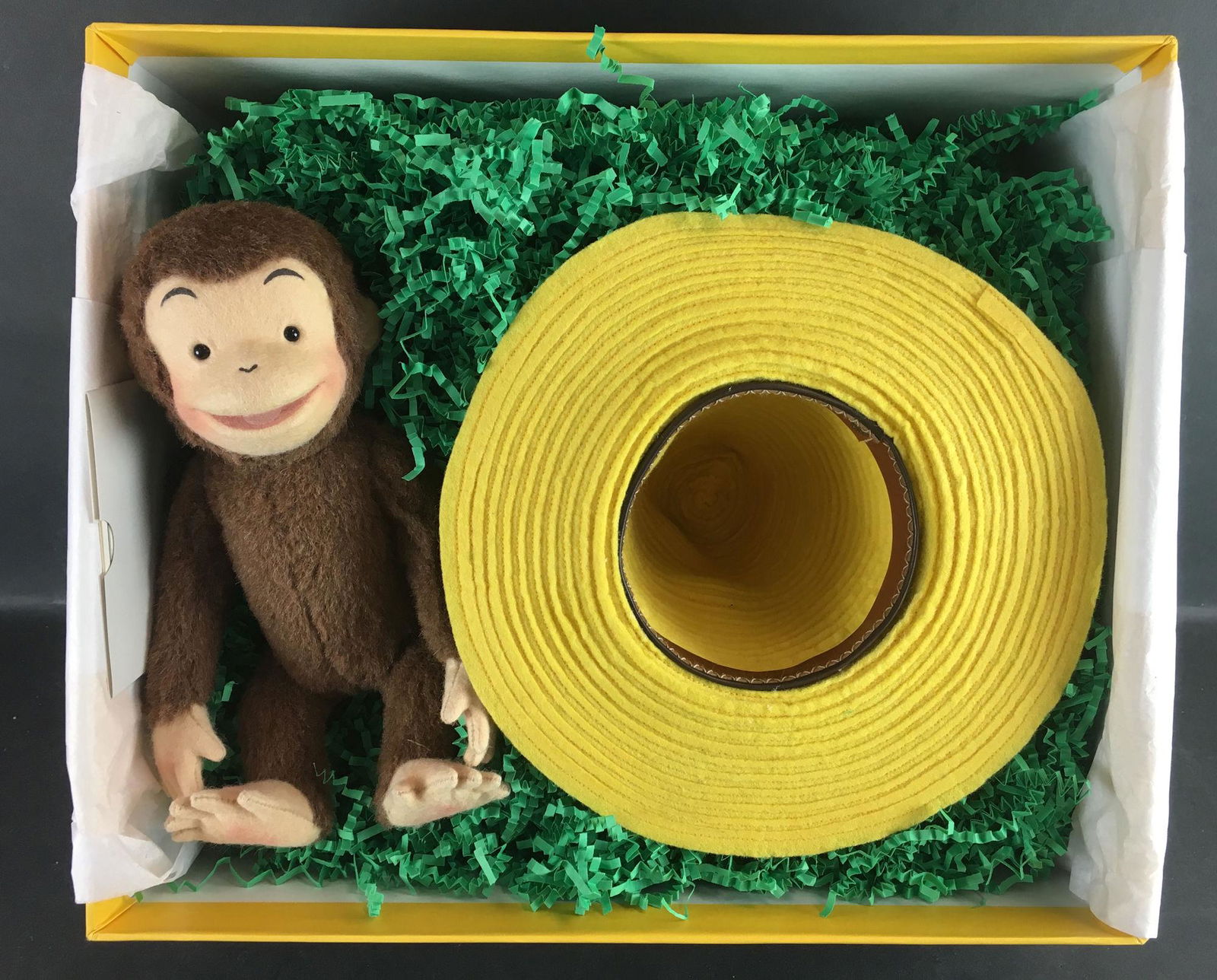 R. JOHN WRIGHT "CURIOUS GEORGE AND THE YELLOW HAT" IN: R. JOHN WRIGHT "CURIOUS GEORGE AND THE YELLOW HAT" IN ORIGINAL BOX WITH COA. LTD ED. #059/500. 9" CURIOUS GEORGE IS FULLY JOINTED, MADE OF ALPACA PLUSH AND MOLDED FELT FACE WITH GLASS EYES. FELT HANDS