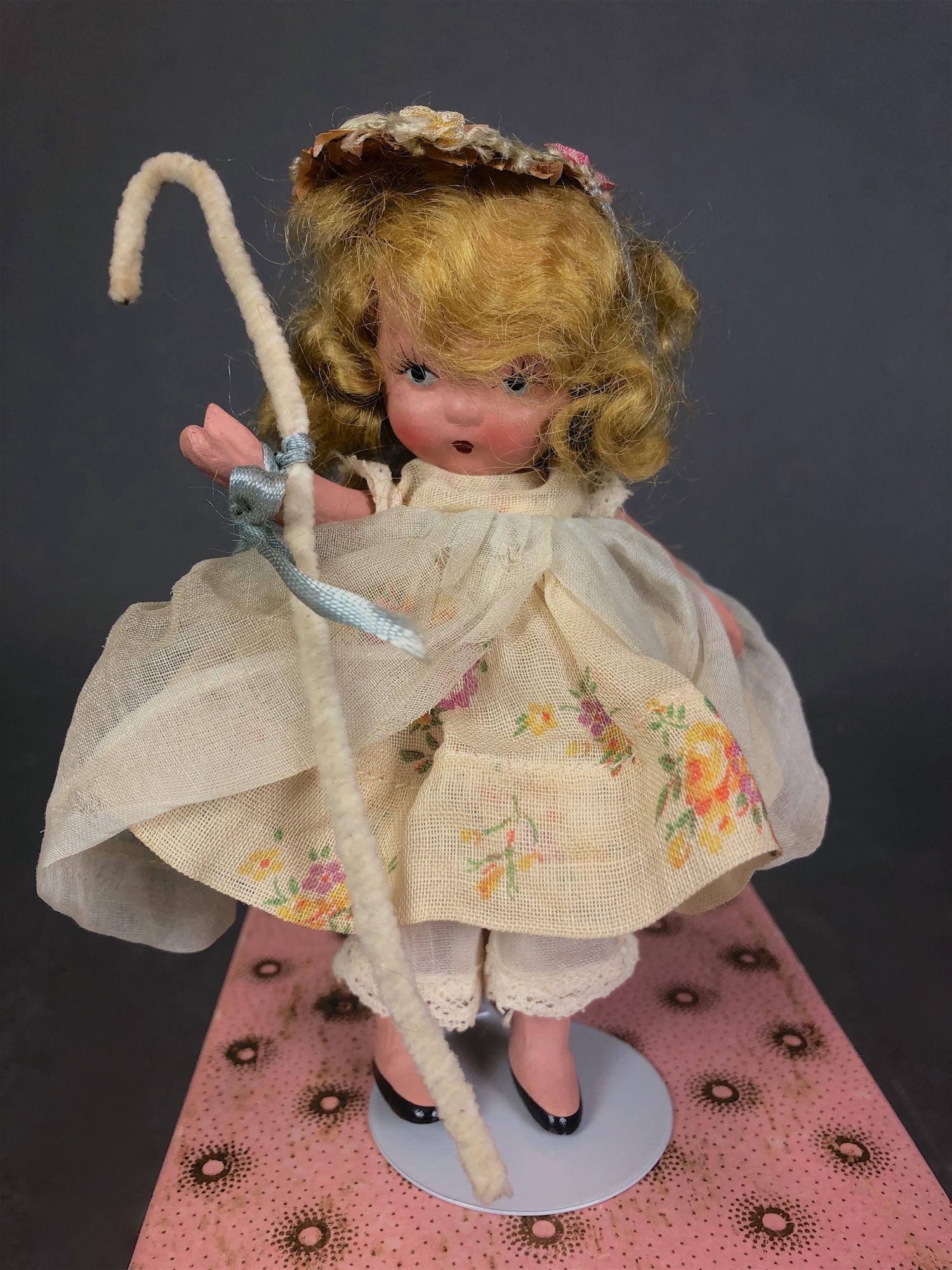 5¼" JUDY ANN STORYBOOK DOLL IN ORIGINAL COSTUME.: 5¼" JUDY ANN STORYBOOK DOLL IN ORIGINAL COSTUME. "JUDY ANN USA" MARK ON JOINTED PT BISQUE BODY, MOLDED SOCKS AND PAINTED BLACK SLIPPERS. COMES WITH PINK SUNBURST BOX AND GOLD FOIL LABEL "LITTLE