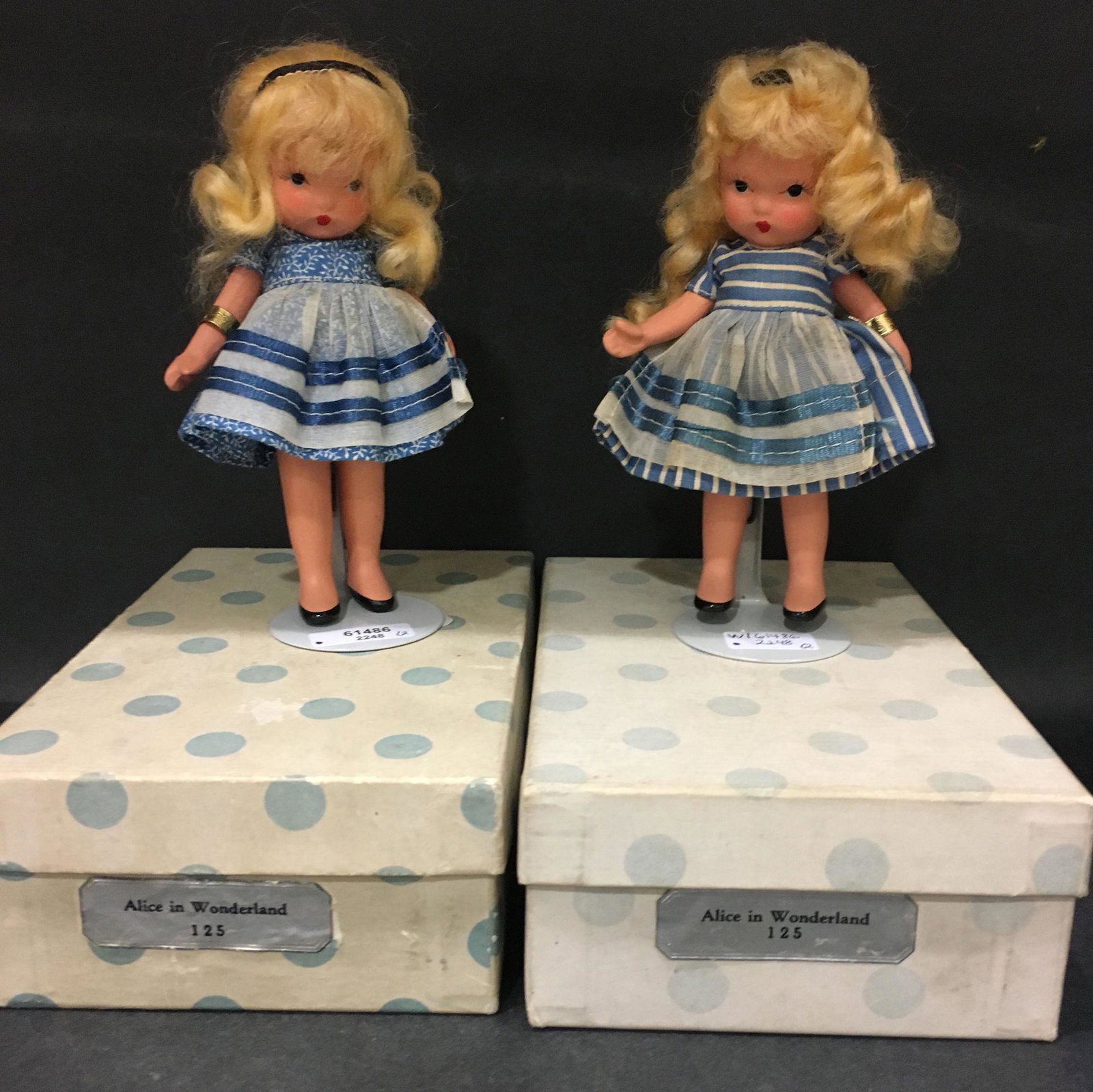 (2) 5¼" NANCY ANN STORYBOOK "ALICE IN: (2) 5¼" NANCY ANN STORYBOOK "ALICE IN WONDERLAND" #125 DOLLS WITH "STORYBOOK DOLLS USA" MARK ON JOINTED PT BISQUE BODIES. BOTH HAVE GOLD FOIL WRIST TAG MARKED "ALICE IN WONDERLAND" #125. EACH D