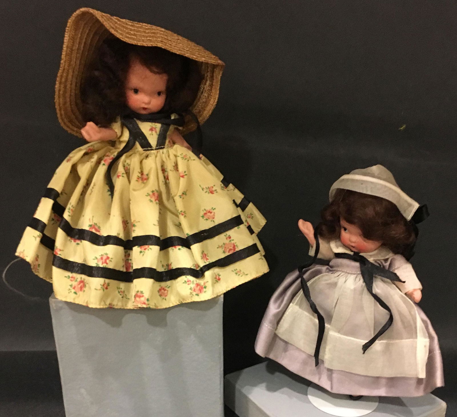 (2) 5½" STORYBOOK DOLLS AMERICAN GIRL SERIES IN: (2) 5½" STORYBOOK DOLLS AMERICAN GIRL SERIES IN ORIGINAL COSTUMES. 1.) "QUAKER MAID" #55 WITH "JUDY ANN USA" MARK ON JOINTED PT BISQUE BODY WITH MOLDED SOCKS/BANGS. ONLY RESIDUE REMAINS OF COST