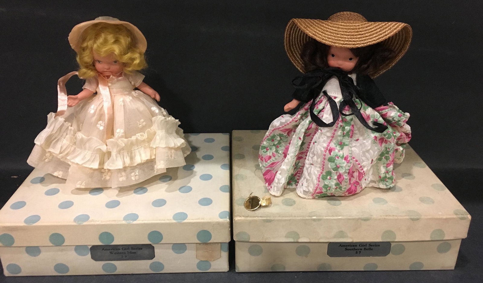 (2) 5½" STORYBOOK "AMERICAN GIRL SERIES" DOLLS: (2) 5½" STORYBOOK "AMERICAN GIRL SERIES" DOLLS IN ORIGINAL COSTUMES. 1.) "WESTERN MISS" #58 WITH "JUDY ANN USA" MARK ON JOINTED PT BISQUE BODY WITH MOLDED SOCKS/BANGS. COMES IN WHITE BOX/BLUE D
