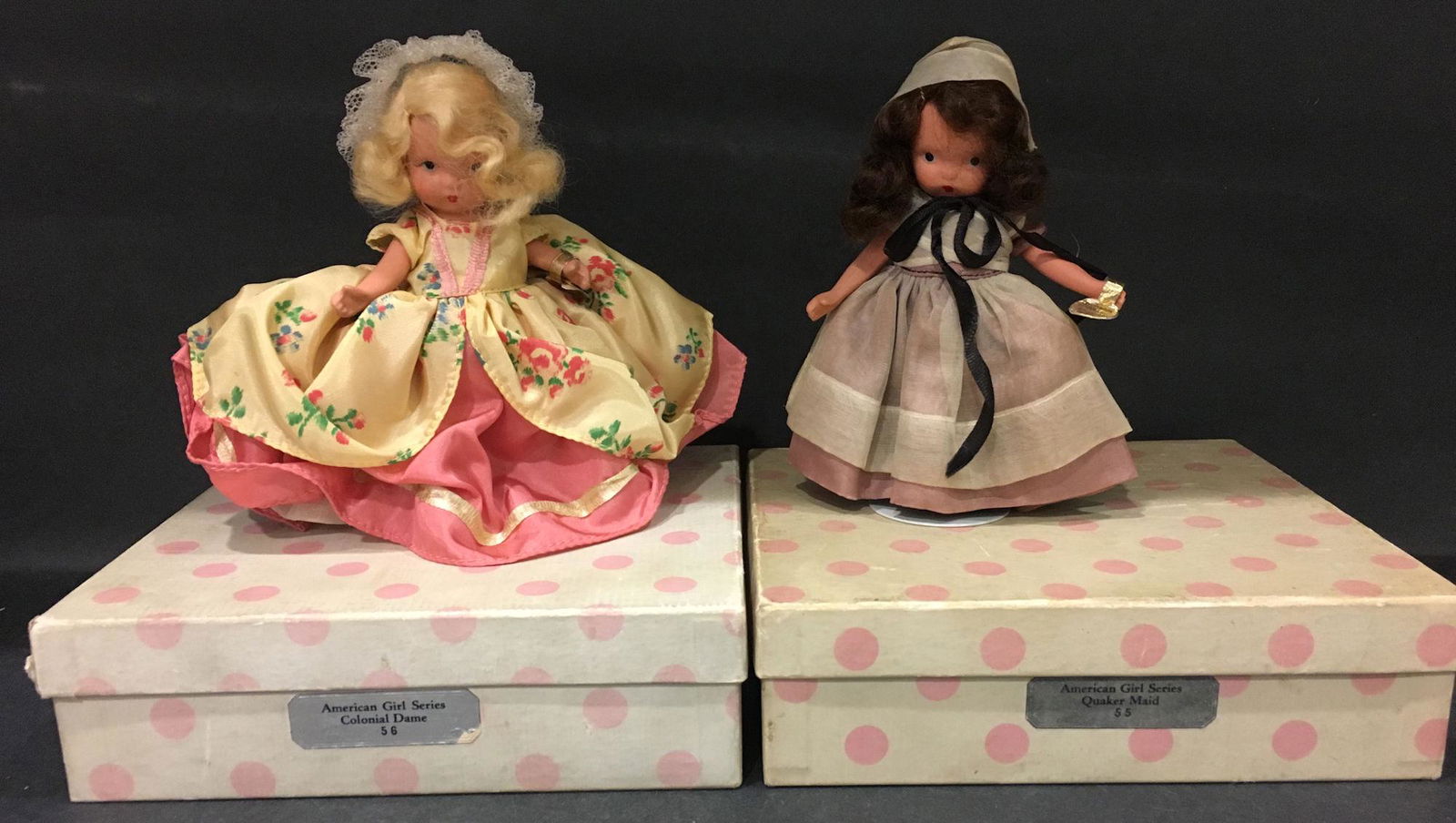 (2) 5½" STORYBOOK DOLLS AMERICAN GIRL SERIES IN: (2) 5½" STORYBOOK DOLLS AMERICAN GIRL SERIES IN ORIGINAL COSTUMES. "COLONIAL DAME" #56 AND "QUAKER MAID" #55. "STORY BOOK DOLL USA" MARK ON JOINTED SLIM BISQUE BODIES WEARING GOLD FOIL WRIST TA