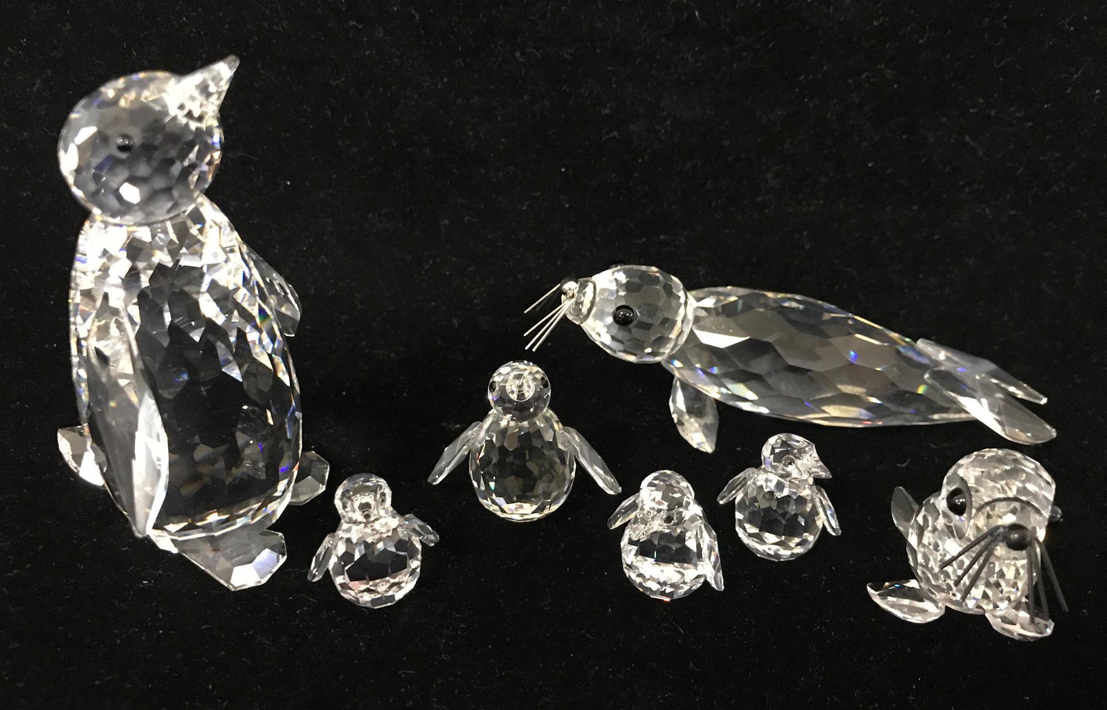 7 SWAROVSKI CRYSTAL ANIMALS - LARGE AND SMALL WALRUSES,: 8 SWAROVSKI CRYSTAL ANIMALS - LARGE AND SMALL WALRUSES, LARGE, SMALL AND 3 TINY PENGUINS, ¾" TO 3." ORIGINAL BOXES INCLUDED
