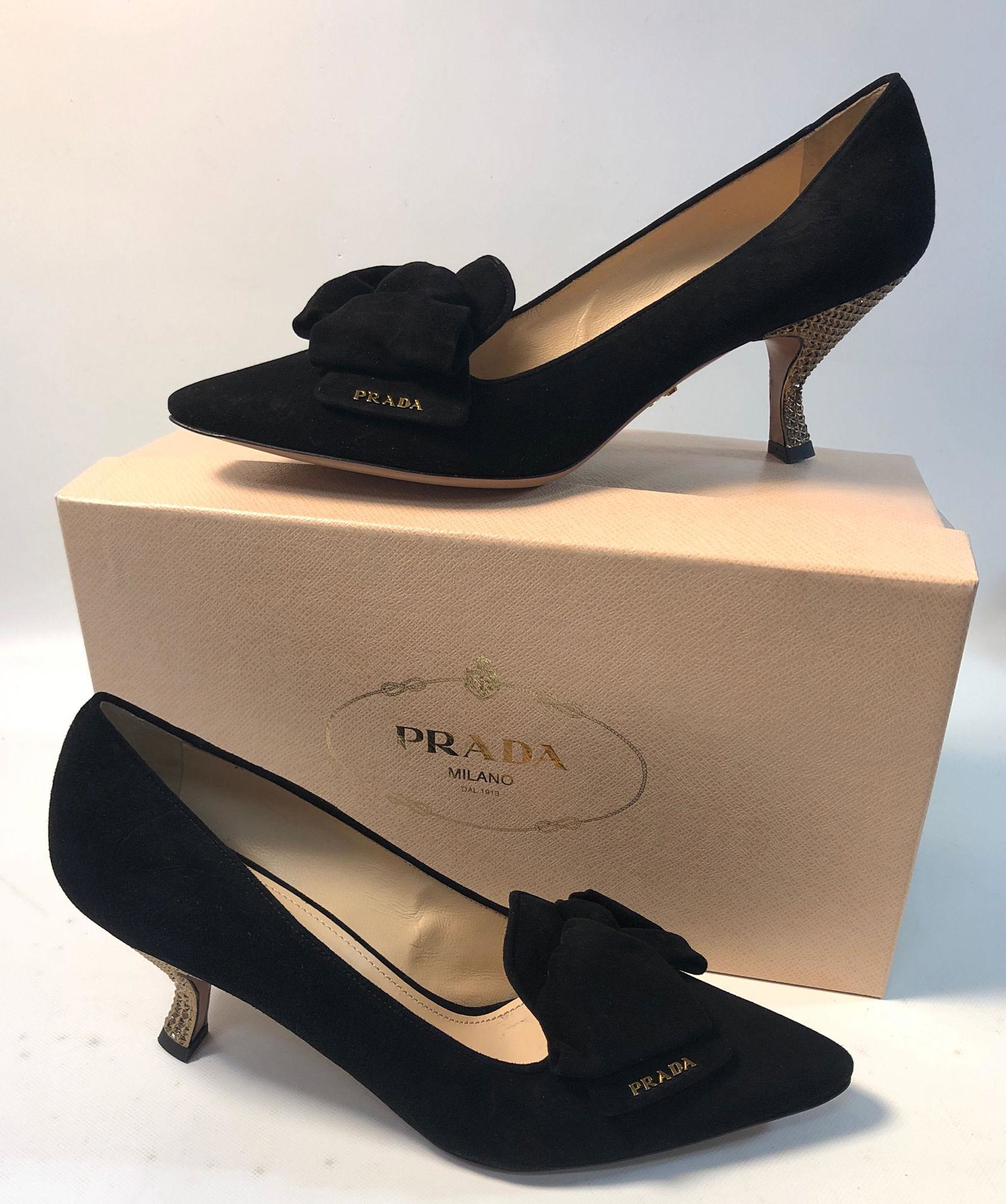 PRADA MILANO SHOES: PRADA MILANO SHOES ~ NEW IN BOX, SIZE 40 EU, POINTED TOW, BLACK SUEDE W/ BOW ACCENT, ART GROUP CAMOSICO BICOLO, NO. 11899D, TAPERED GEOMETRIC GOLD TONE HEEL, GOLD TONE BRANDED ACCENT, APPROX 3" HEEL,