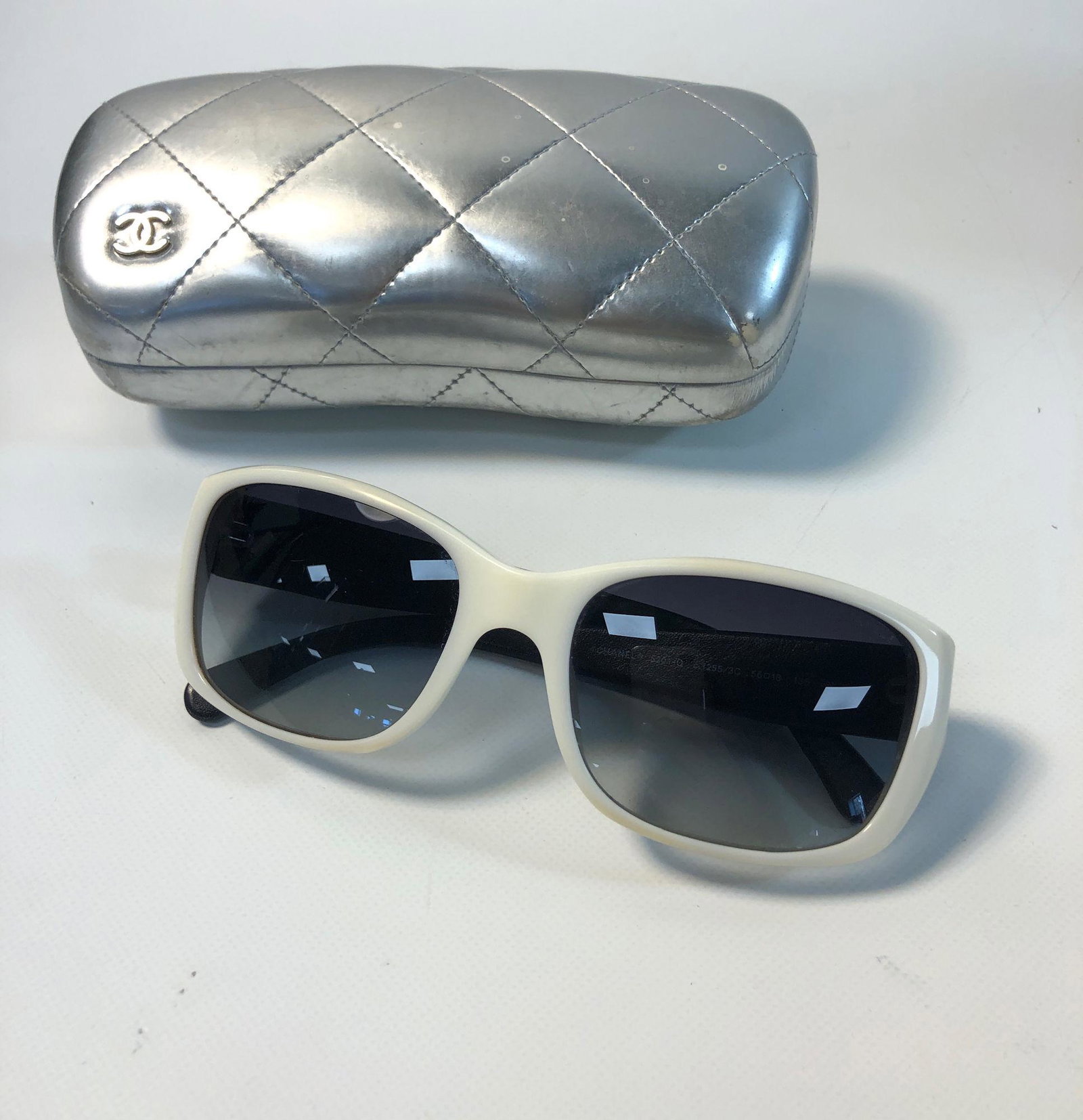 CHANEL SUNGLASSES: CHANEL SUNGLASSES ~ QUILTED BLACK LEATHER ARMS, WHITE PLASTIC FRAMES, ITALIAN MADE, GOOD CONDITION WITH SLIGHT DISCOLORATION ON BRIDGE, NO. 5201-Q, IN BRANDED CASE-DAMAGED
