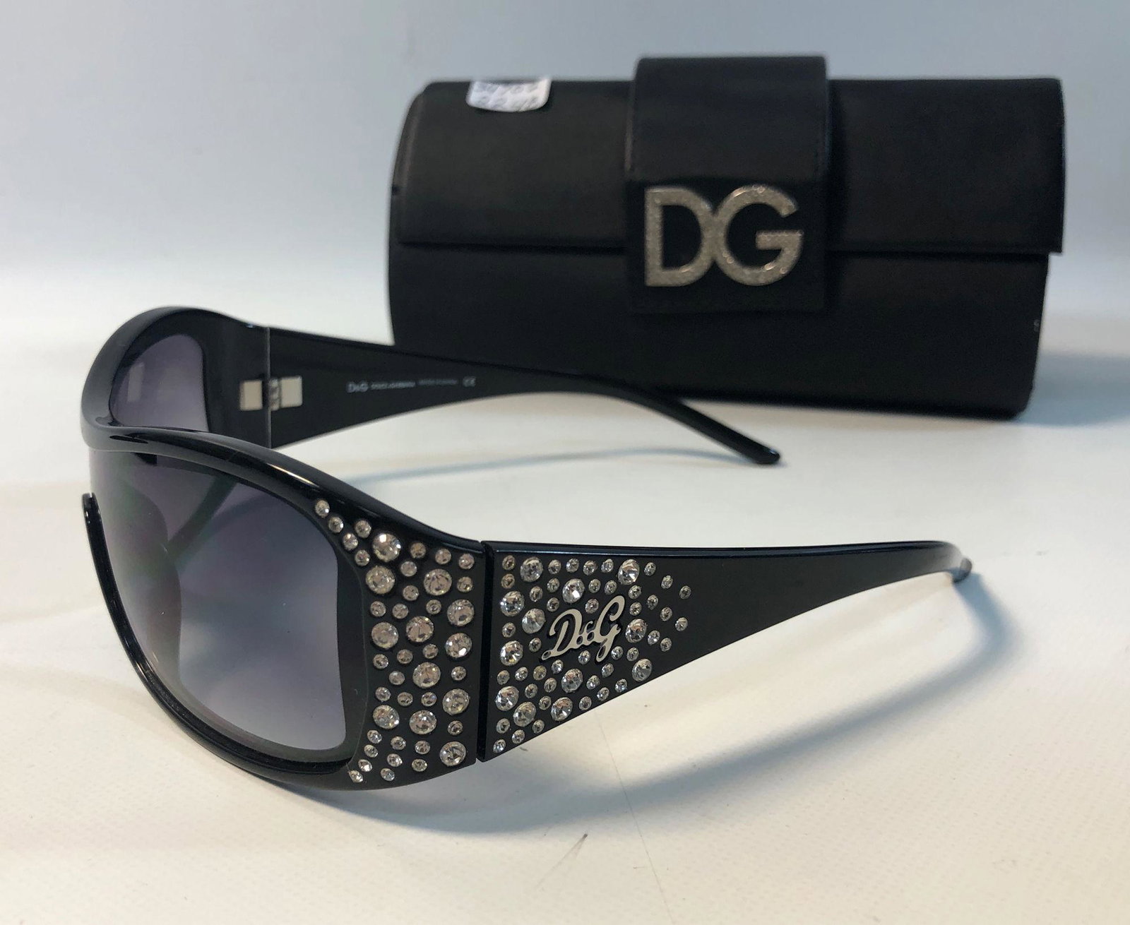 DOLCE & GABBANA SUNGLASSES: DOLCE & GABBANA SUNGLASSES ~ BLACK FRAMES, CONTINUOUS SINGLE LENS, CRYSTAL ACCENTS W/ SILVER TONE D&G DETAIL, LIKE NEW CONDITION WITH ONE DISCOLORED CRYSTAL, IN BRANDED CASE, NO. 8041B