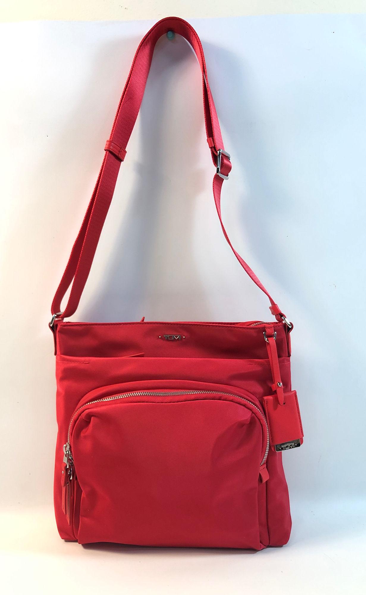 TUMI CROSSBODY BAG: TUMI CROSSBODY BAG ~ LIKE NEW CONDITION, RASPBERRY RED NYLON W/ LEATHER ACCENTS AND SILVER TONE HARDWARE, FOUR MAIN COMPARTMENTS WITH MULTIPLE POCKETS, ADJUSTABLE LENGTH STRAP, APPROX. 10.5" DEPTH, 12